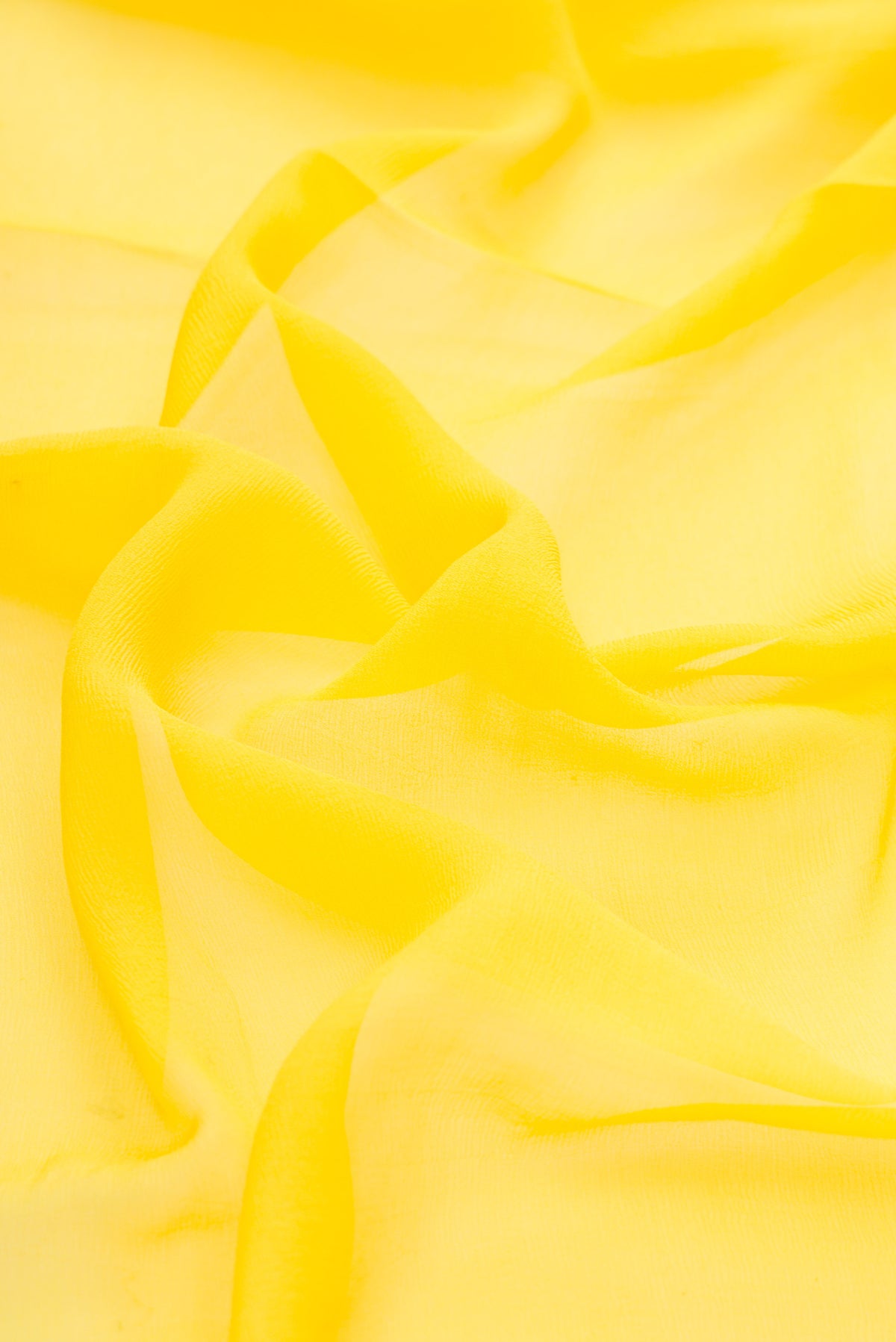 Close up of Lemon Yellow Dual Tone Mysore Chiffon Saree with Plain Body and Zari Border.  displaying folds