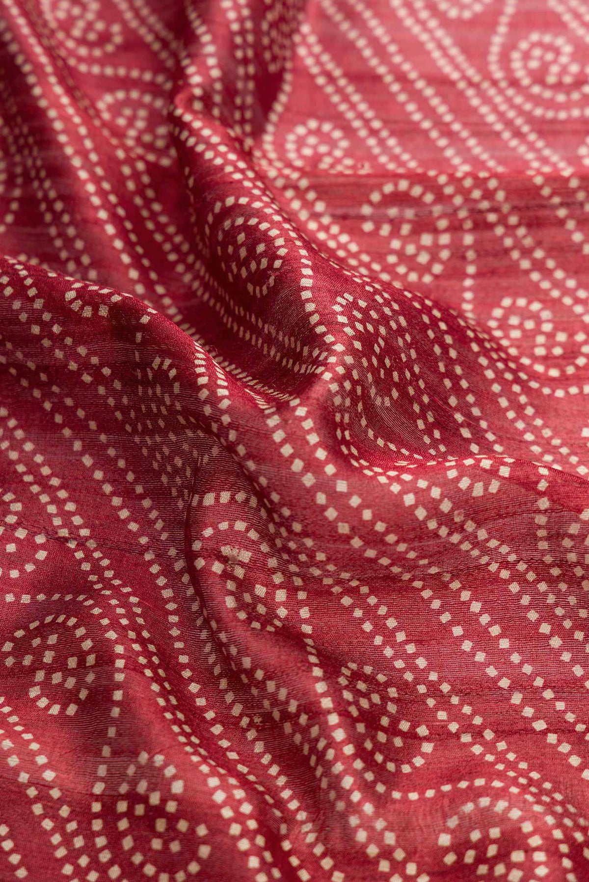 Close up of Dark Pink Dual Tone Tussar Silk Saree with Printed design on the body and Zari Border displaying folds