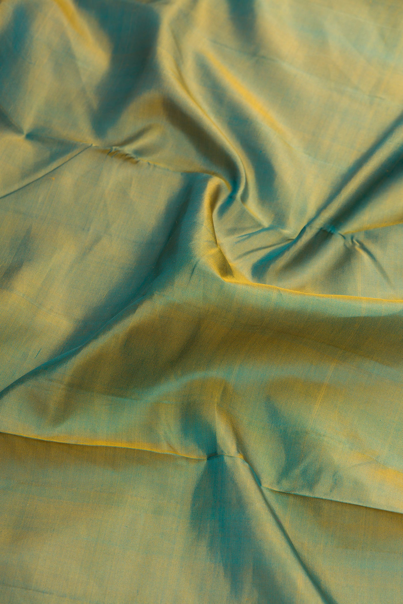Close up of Green Dual Tone Kanjivaram Silk Nine Yards Saree with Stripes on the body and Zari Border.  displaying folds
