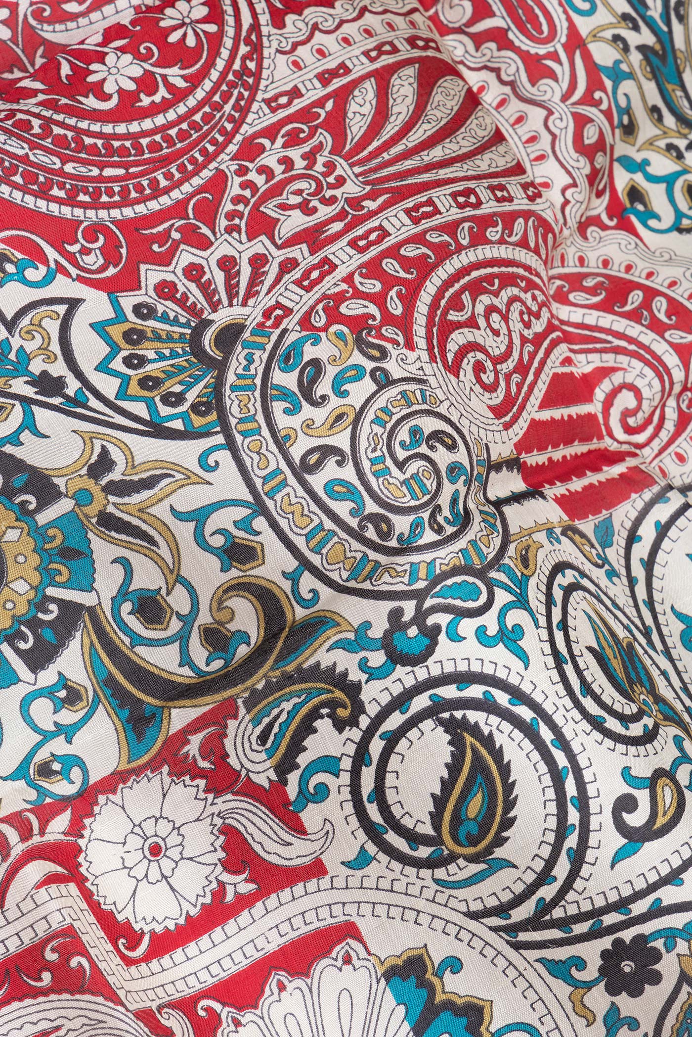 Close up of Off White Printed Silk Saree with Printed design on the body and Plain Border.  displaying folds