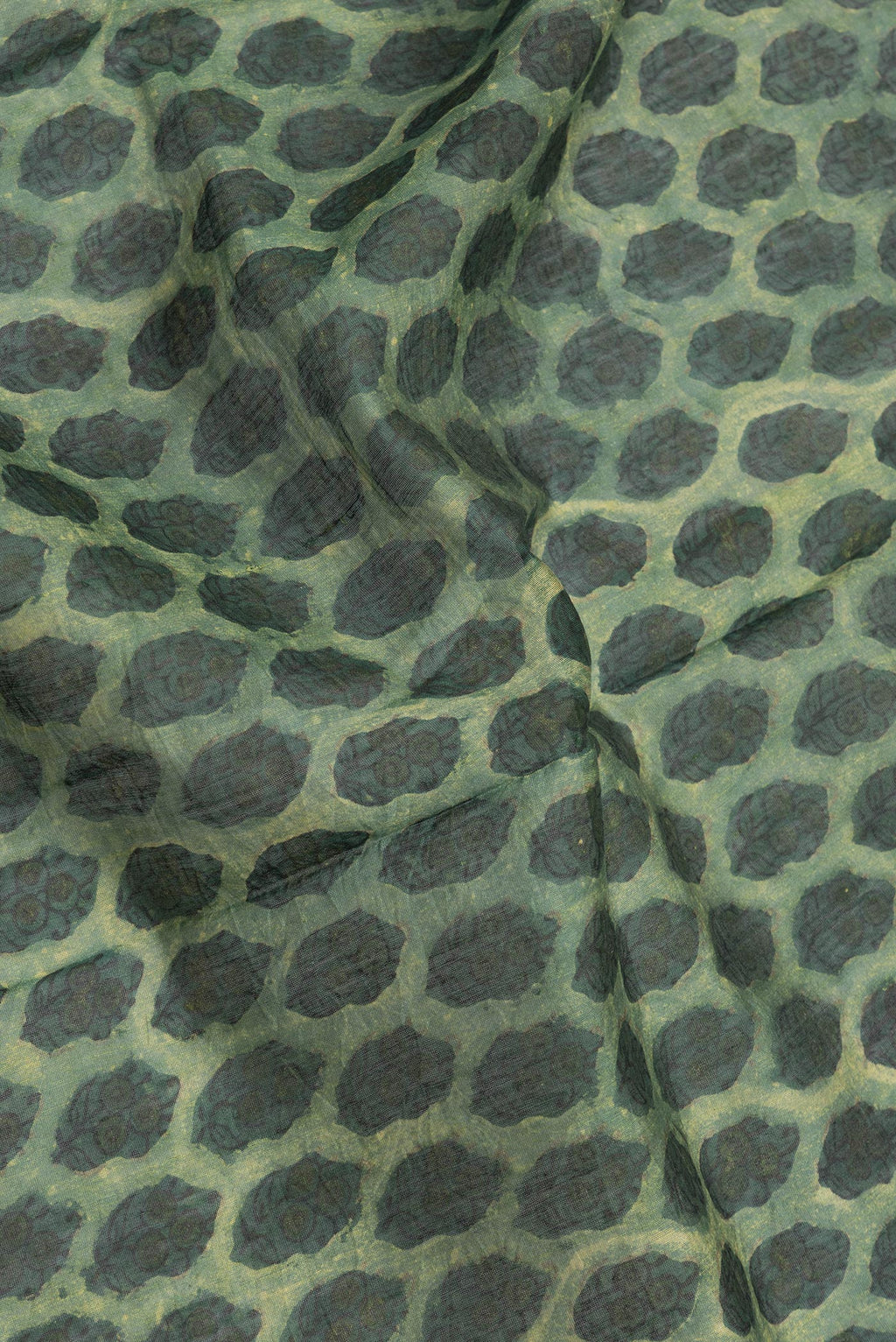 Close up of Green Dual Tone Chanderi Silk Saree with Printed design on the body and Zari Border.  displaying folds