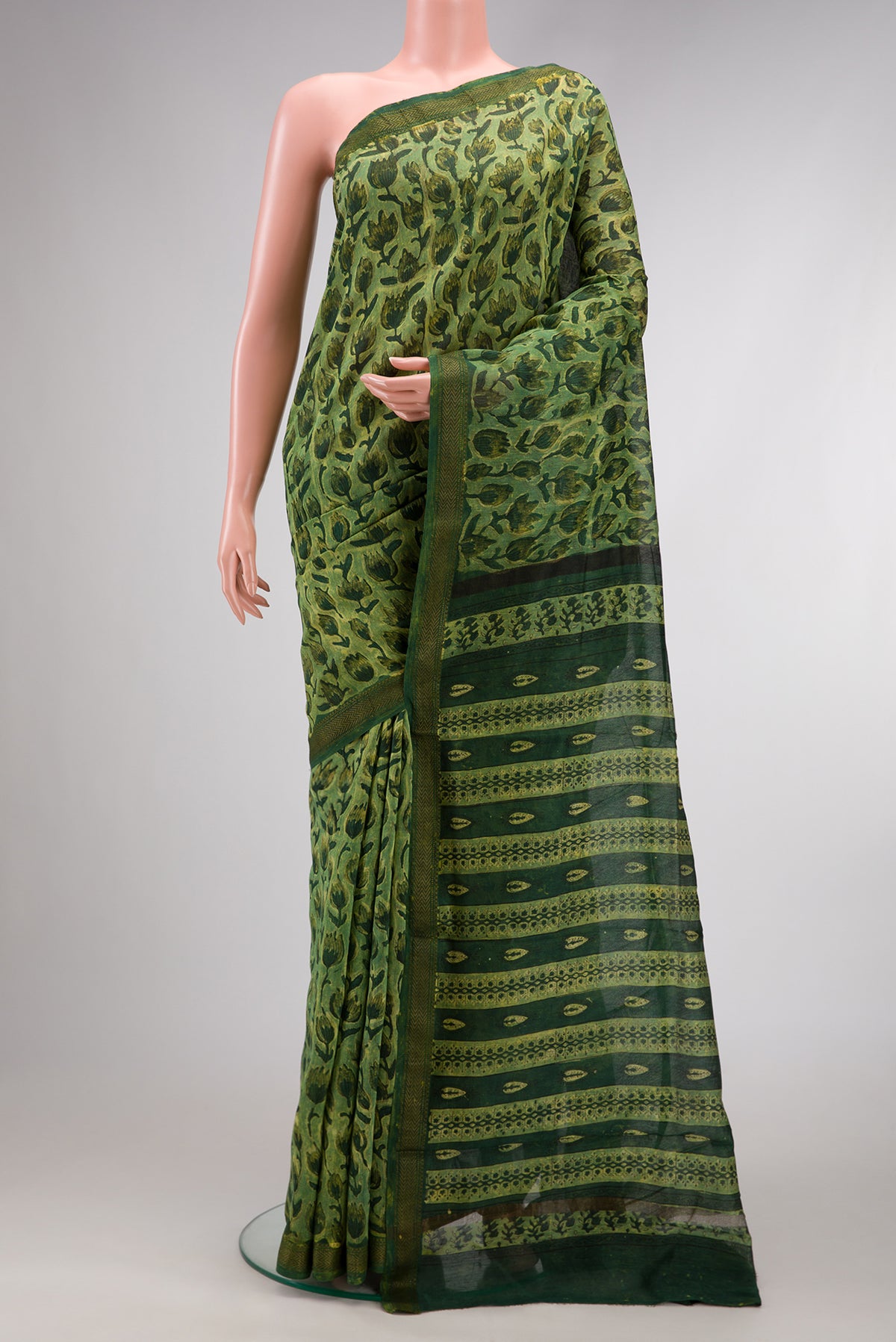 Green Dual Tone Tussar Silk Saree with Printed design on the body and Zari Border.  displayed on a mannequin