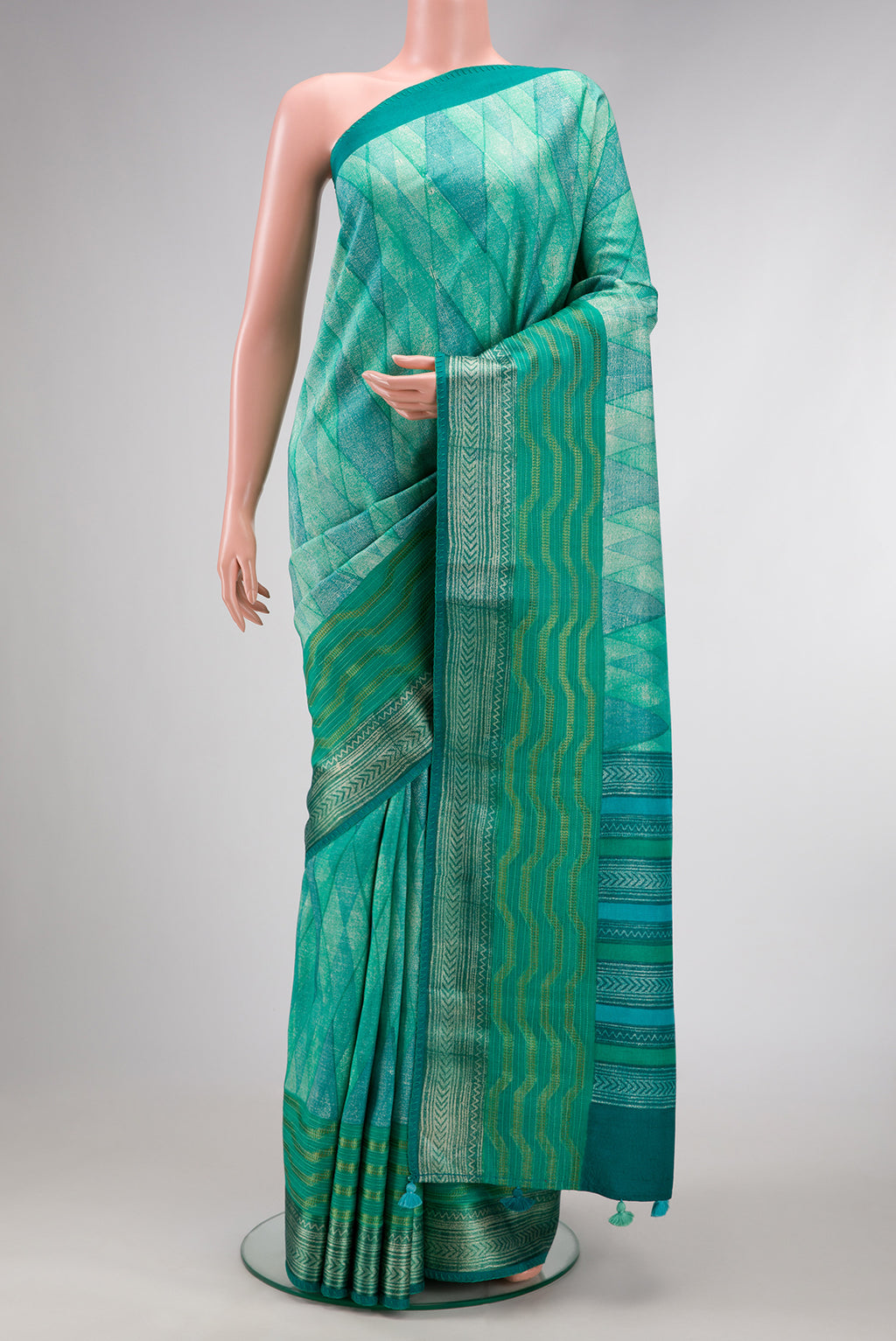 Sea Green Dual Tone Tussar Silk Saree with Printed design on the body and Zari Border.  displayed on a mannequin