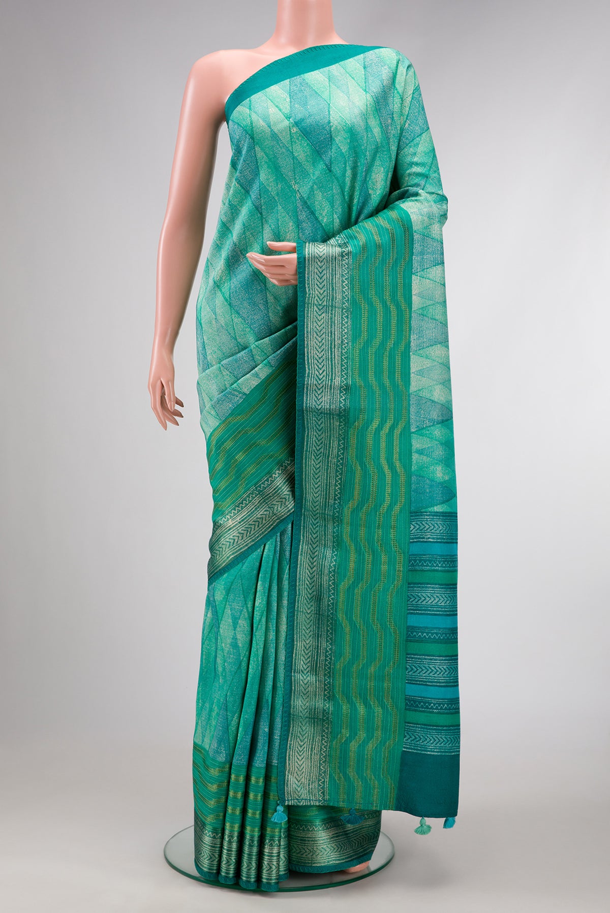 Sea Green Dual Tone Tussar Silk Saree with Printed design on the body and Zari Border.  displayed on a mannequin