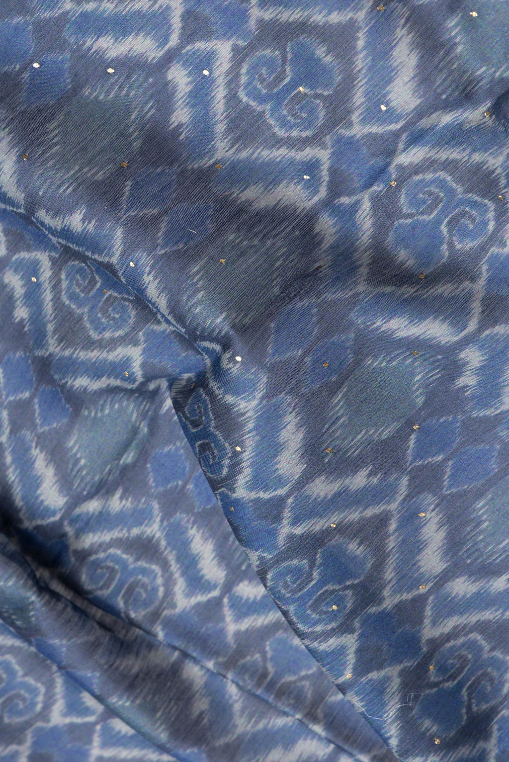 Close up of Blue Dual Tone Chanderi Silk Saree with Printed design on the body and Thread Border.  displaying folds