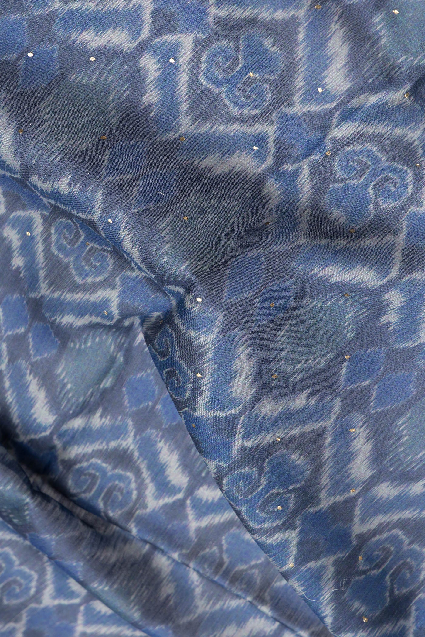 Close up of Blue Dual Tone Chanderi Silk Saree with Printed design on the body and Thread Border.  displaying folds