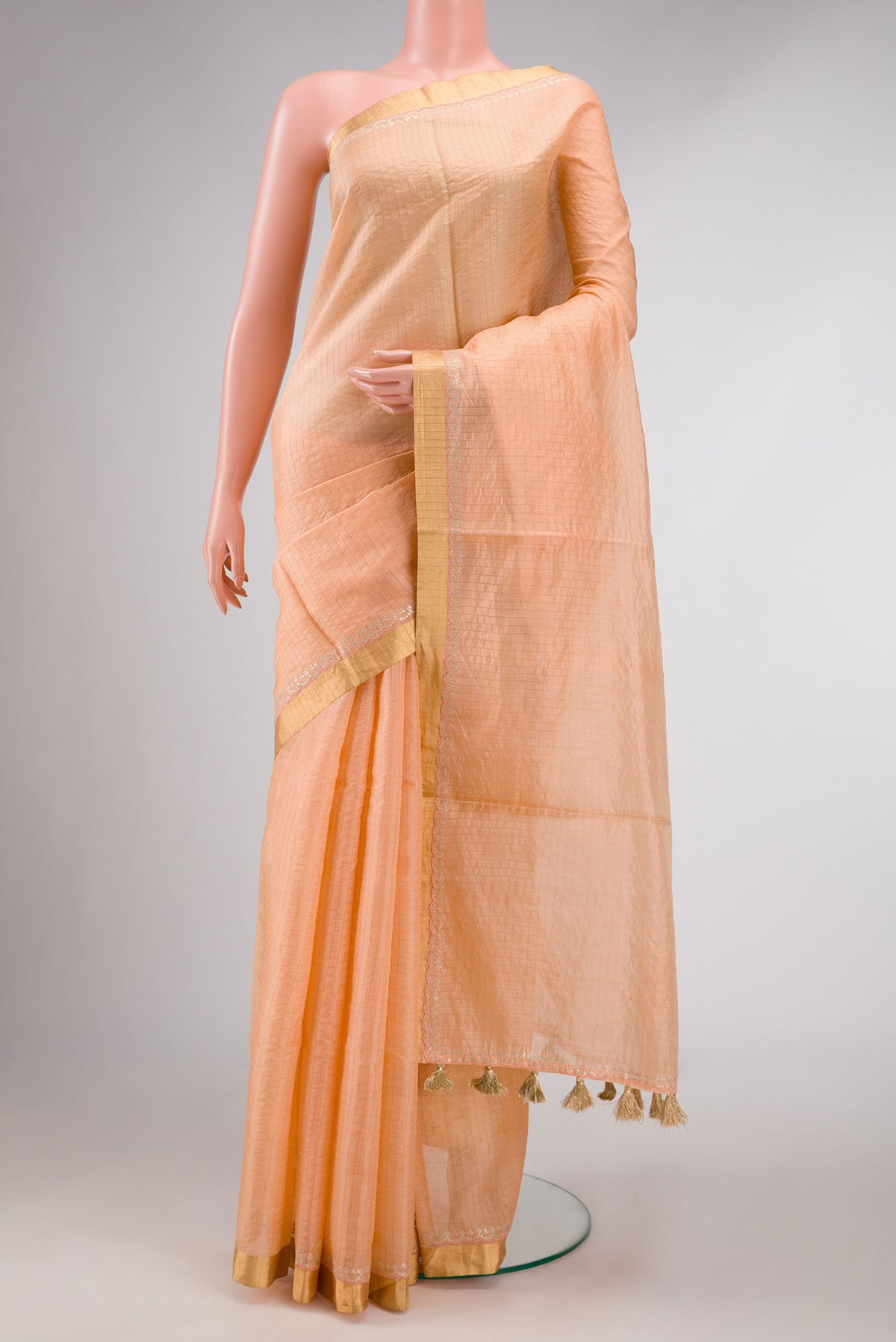 Orange Dual Tone Tussar Silk Saree with Stripes on the body and Zari Border displayed on a mannequin