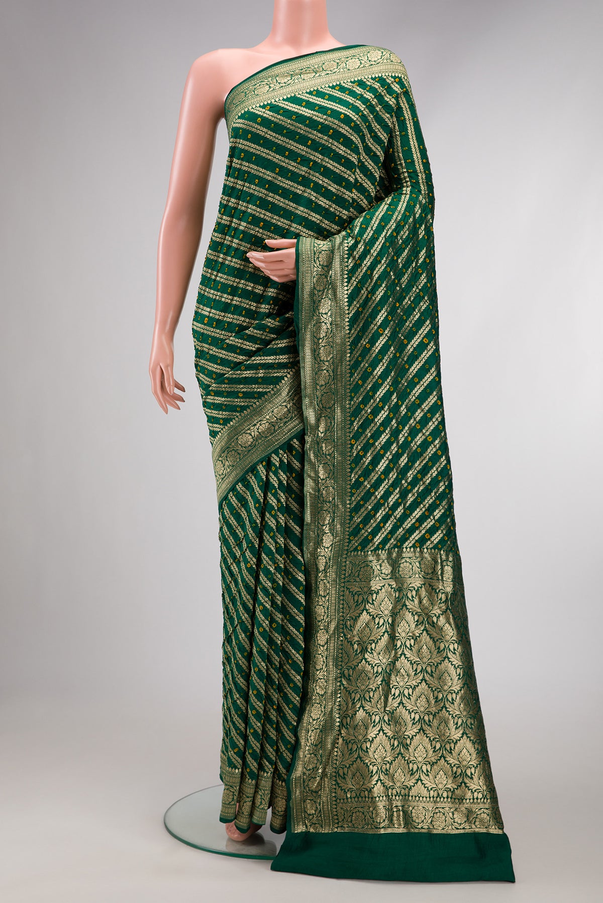 Bottle Green Dual Tone Bandhani Silk Saree with Bandhani Print on the body and Zari Border.  displayed on a mannequin