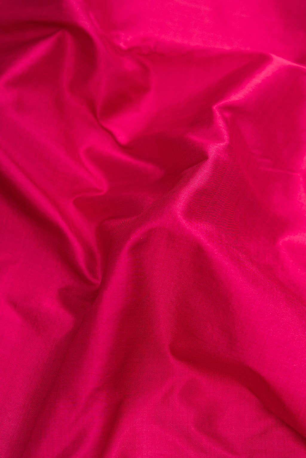 Close up of Maroon Dual Tone Kanchipuram Silk Nine Yards Saree with Plain Body and Zari Border.  displaying folds