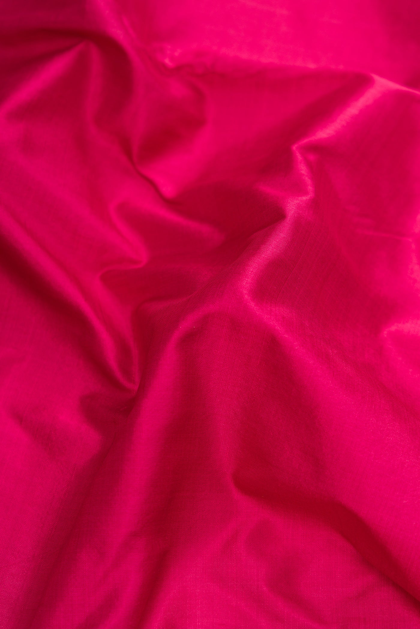 Close up of Maroon Dual Tone Kanchipuram Silk Nine Yards Saree with Plain Body and Zari Border.  displaying folds