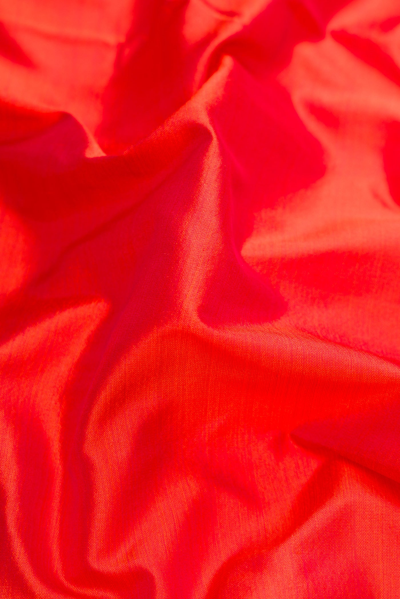 Close up of Orange Dual Tone Kanchipuram Silk Nine Yards Saree with Plain Body and Zari Border.  displaying folds