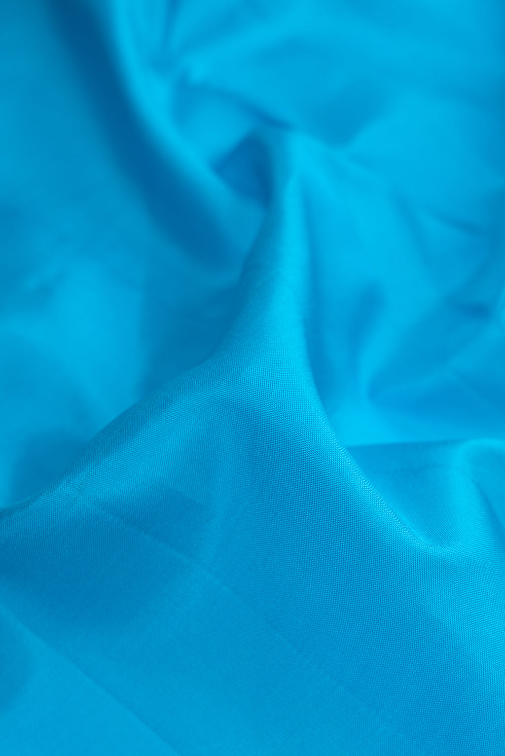 Close up of Sky Blue Dual Tone Kanjivaram Silk Nine Yards Saree with Plain Body and Zari Border.  displaying folds