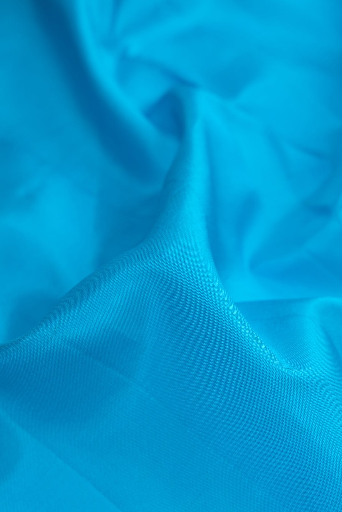 Close up of Sky Blue Dual Tone Kanjivaram Silk Nine Yards Saree with Plain Body and Zari Border.  displaying folds