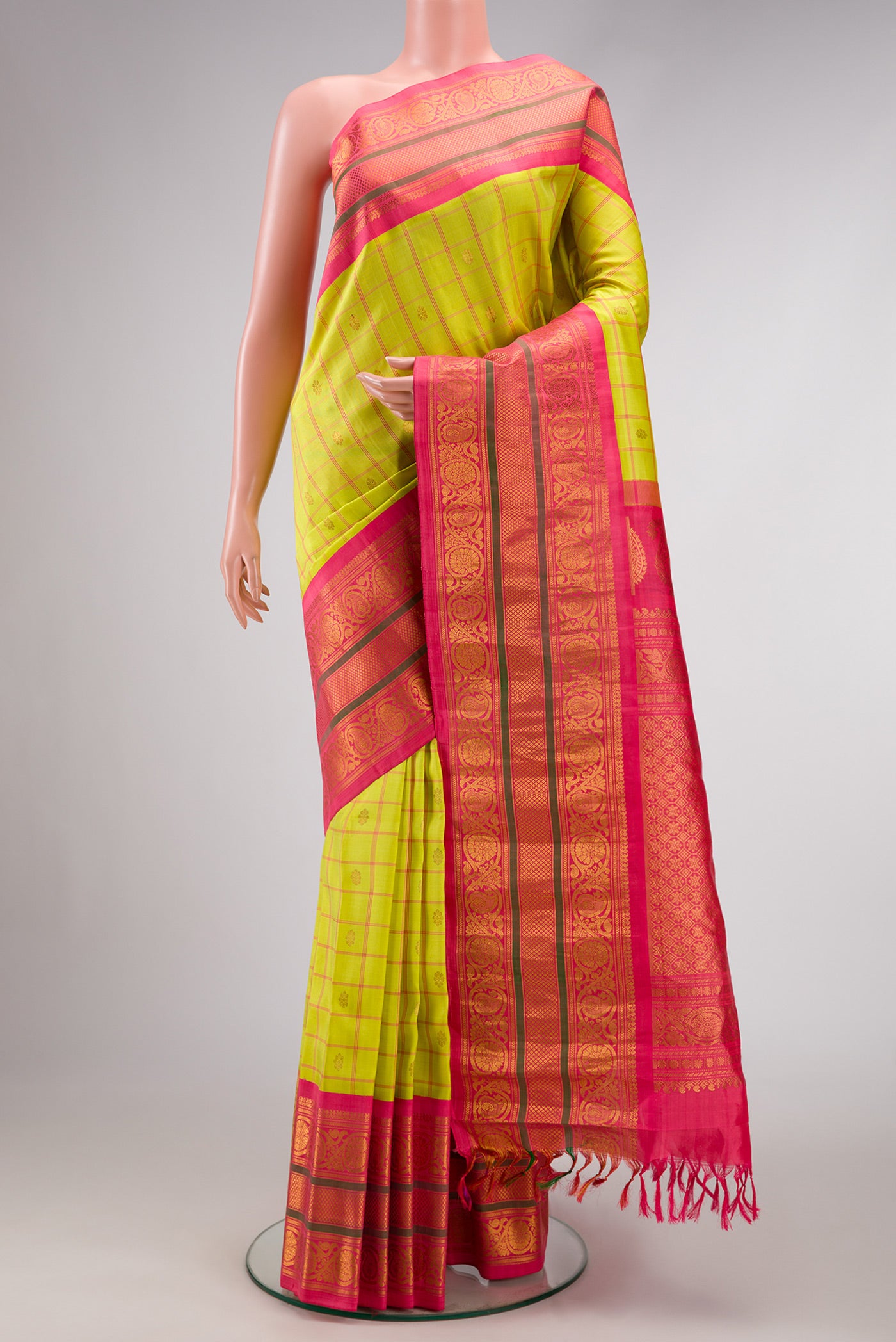 Parrot Green Dual Tone Gadwal Silk Saree with Checked design on the body and Zari Border.  displayed on a mannequin