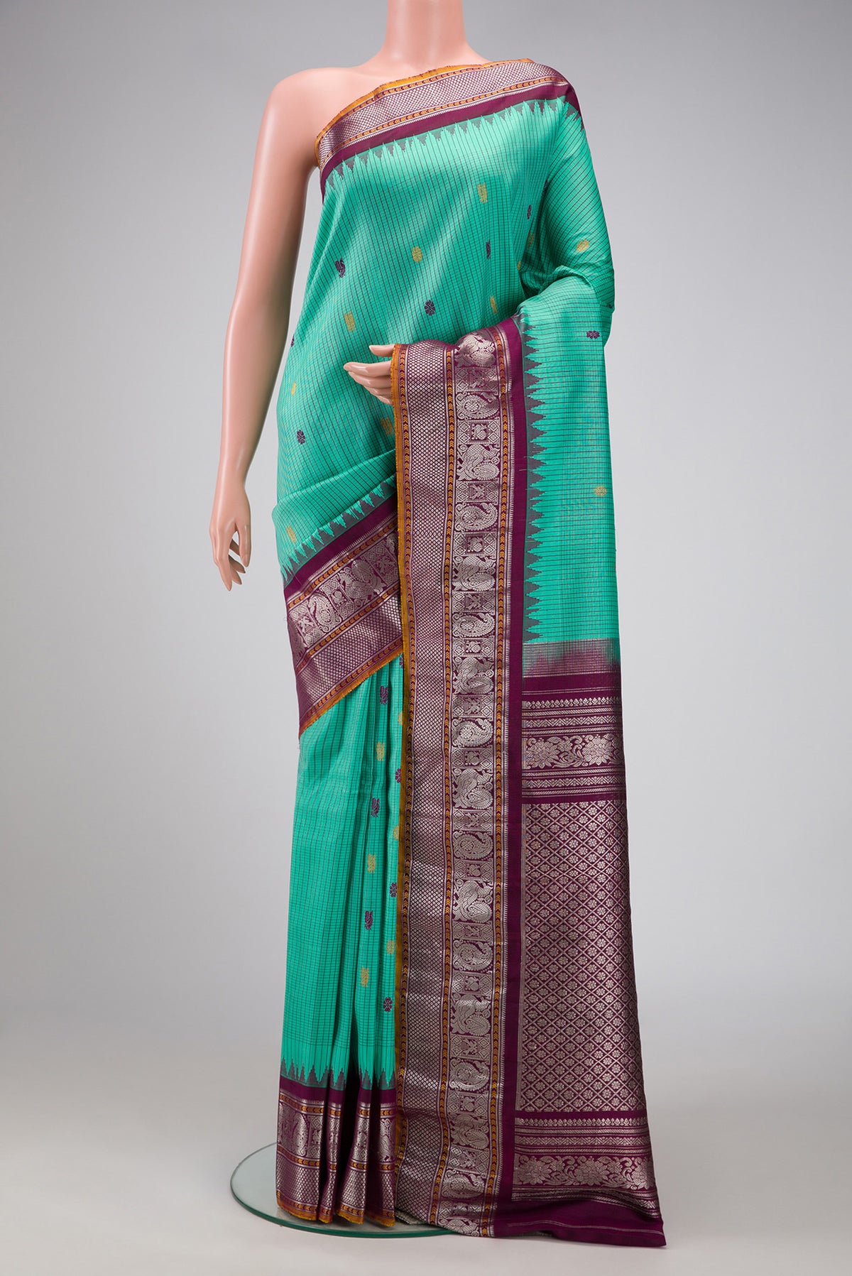 Sea Green Dual Tone Gadwal Silk Saree with Checked design on the body and Zari Border.  displayed on a mannequin