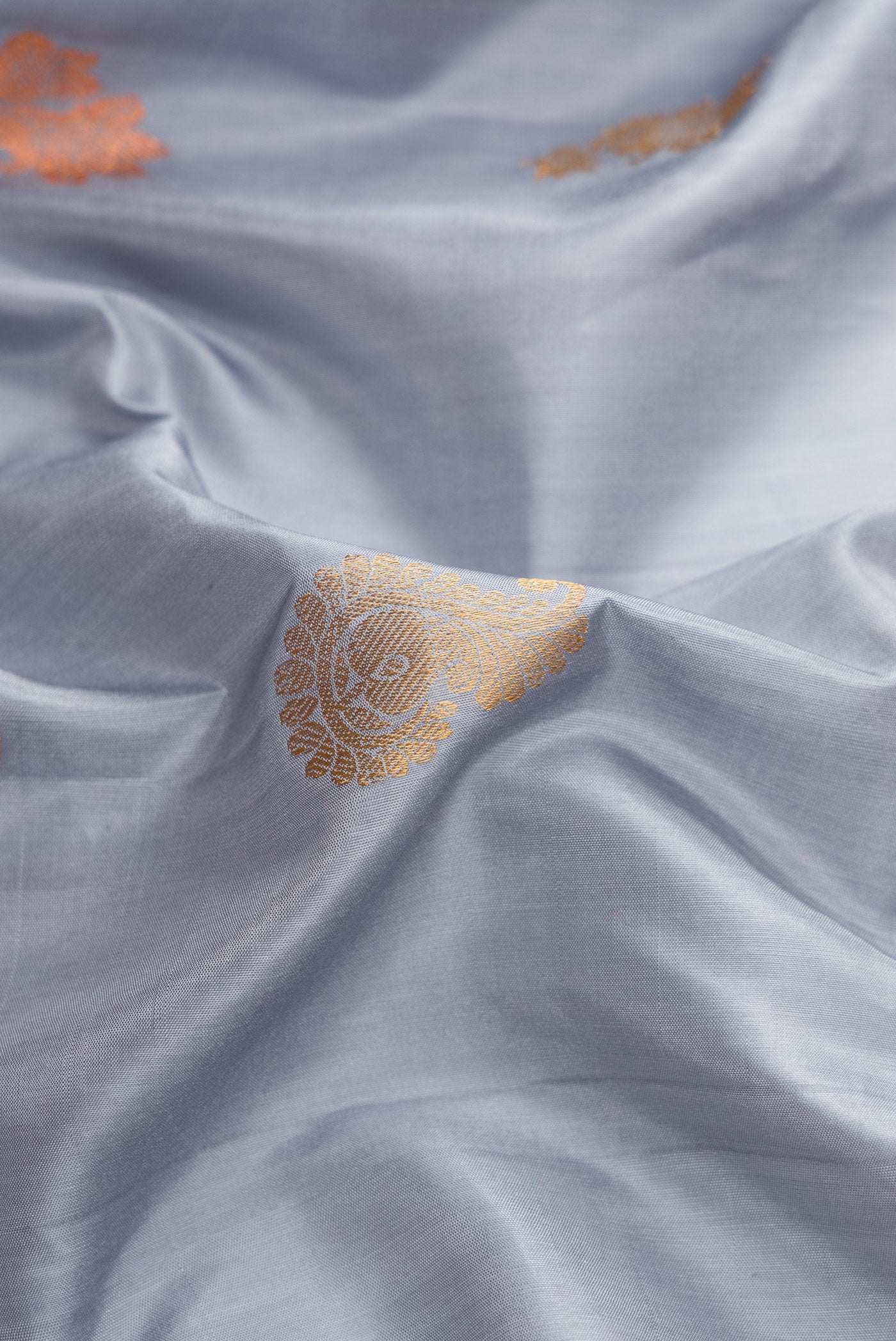 Close up of Grey Dual Tone Gadwal Silk Saree with Zari Butta on the body and Zari Border.  displaying folds