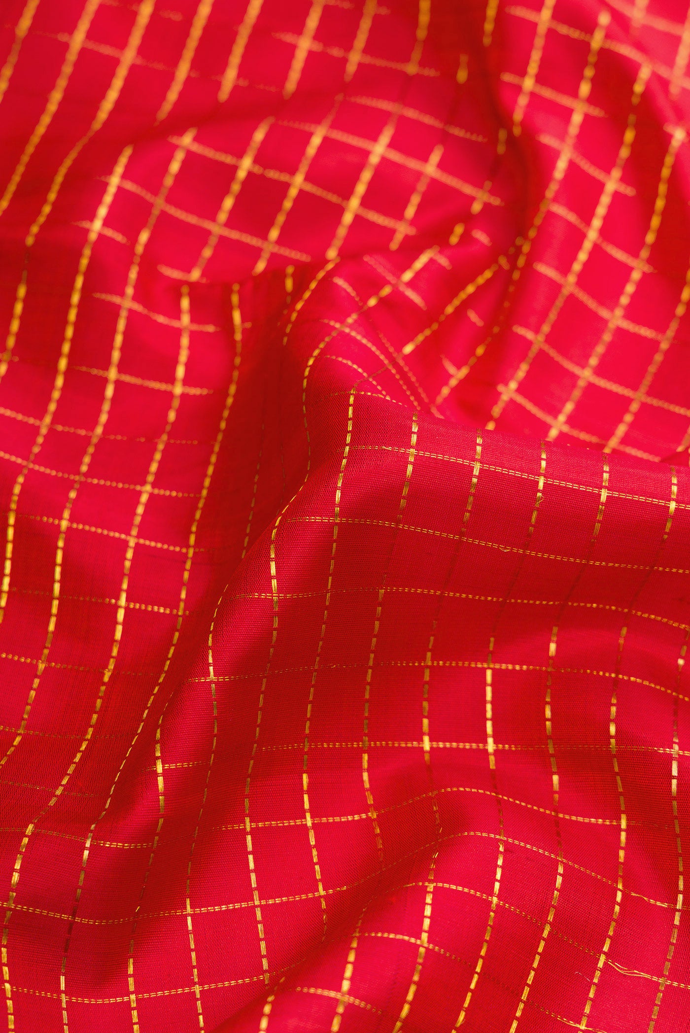 Close up of Red Dual Tone Kanchipuram Silk Nine Yards Saree with Checked design on the body and Zari Border.  displaying folds