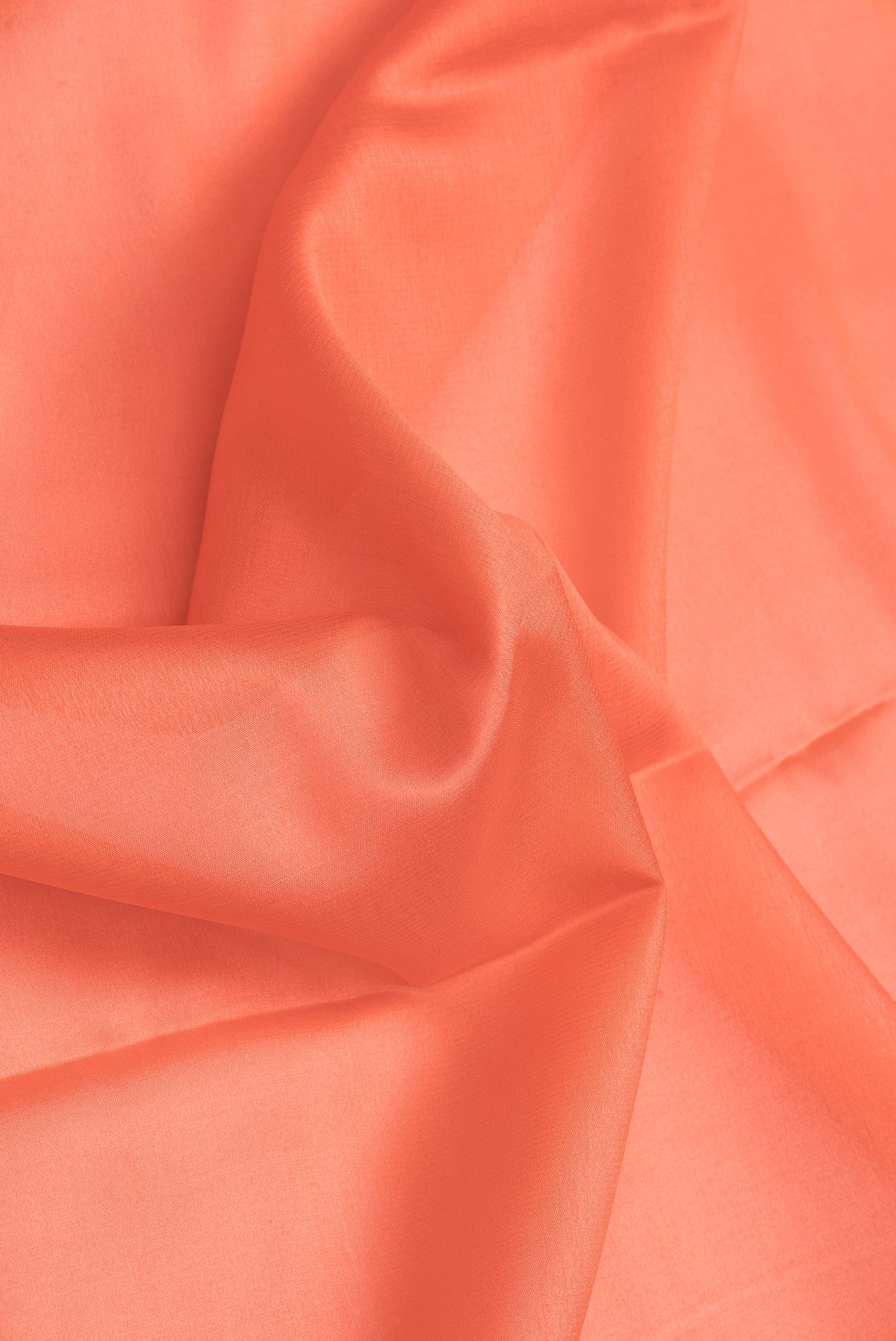 Close up of Peach Dual Tone Mysore Silk Saree with Plain Body and Zari Border.  displaying folds