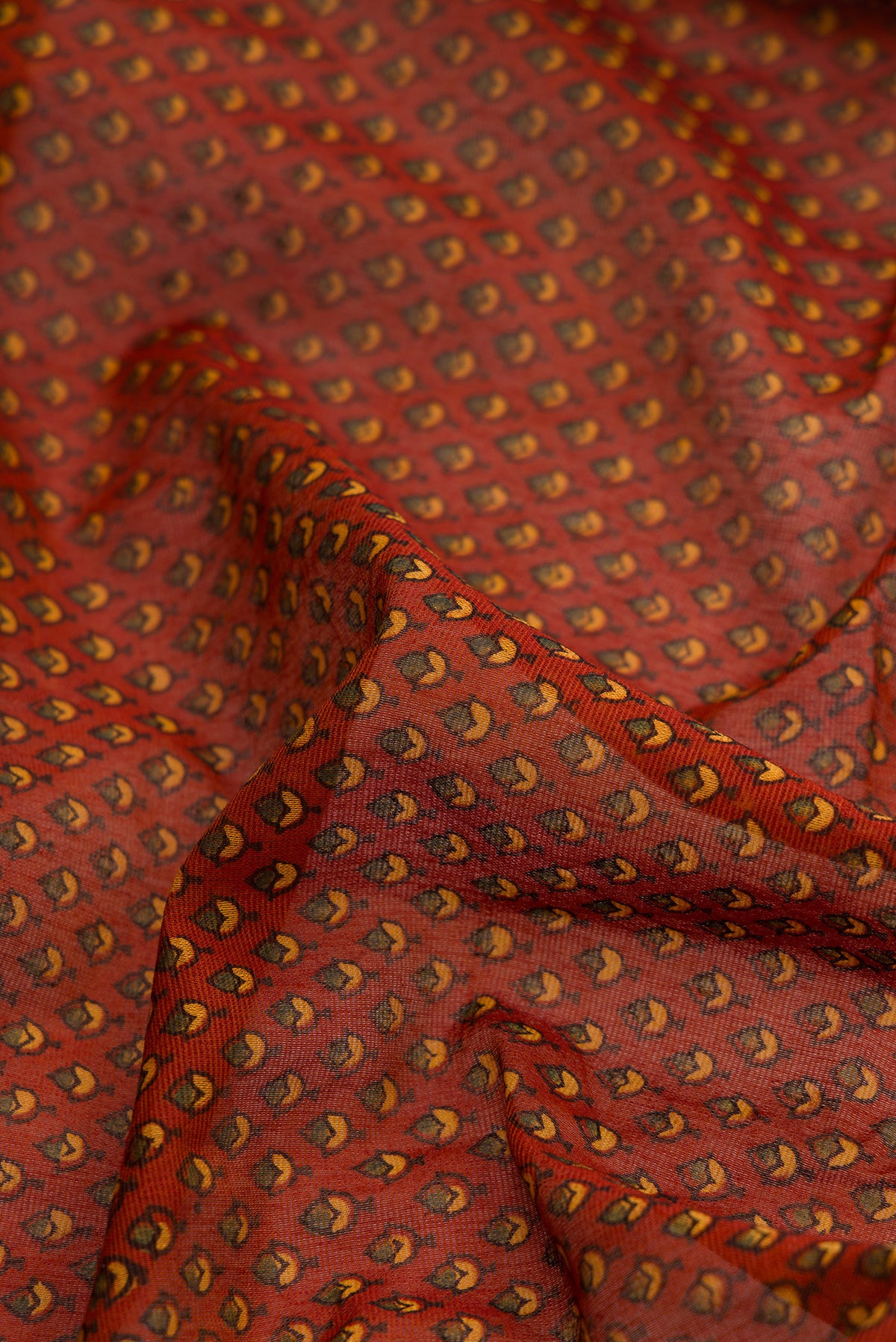Close up of Orange Dual Tone Cotton Saree with Ajrakh Print on the body and Zari Border.  displaying folds