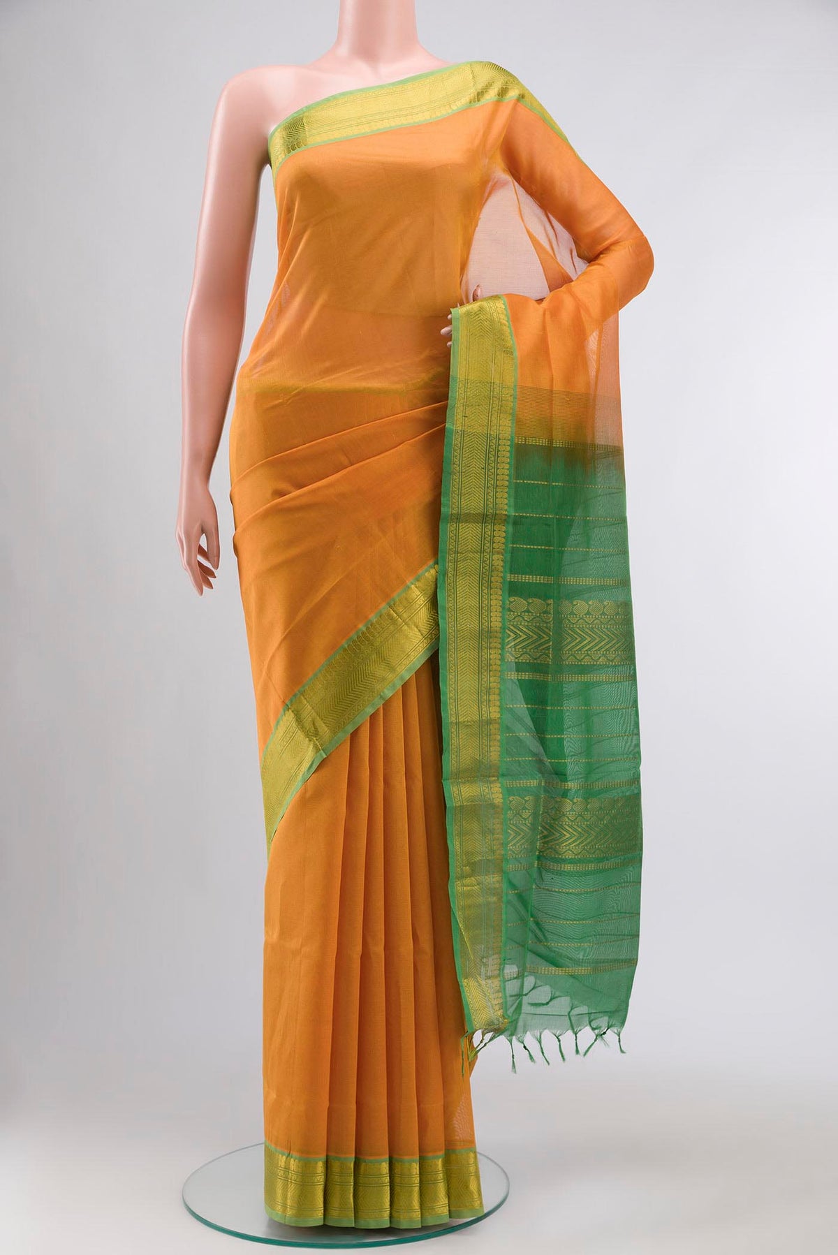 Mustard Silk Cotton Saree with Plain Body and Zari Border displayed on a mannequin