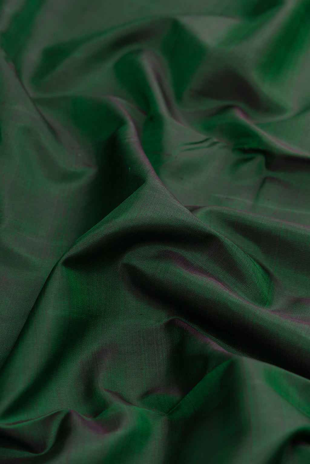 Close up of Pure Silk Pure Zari Bottle Green Dual Tone Kanjivaram Nine Yards Saree with Plain Body and Zari Border.  displaying folds