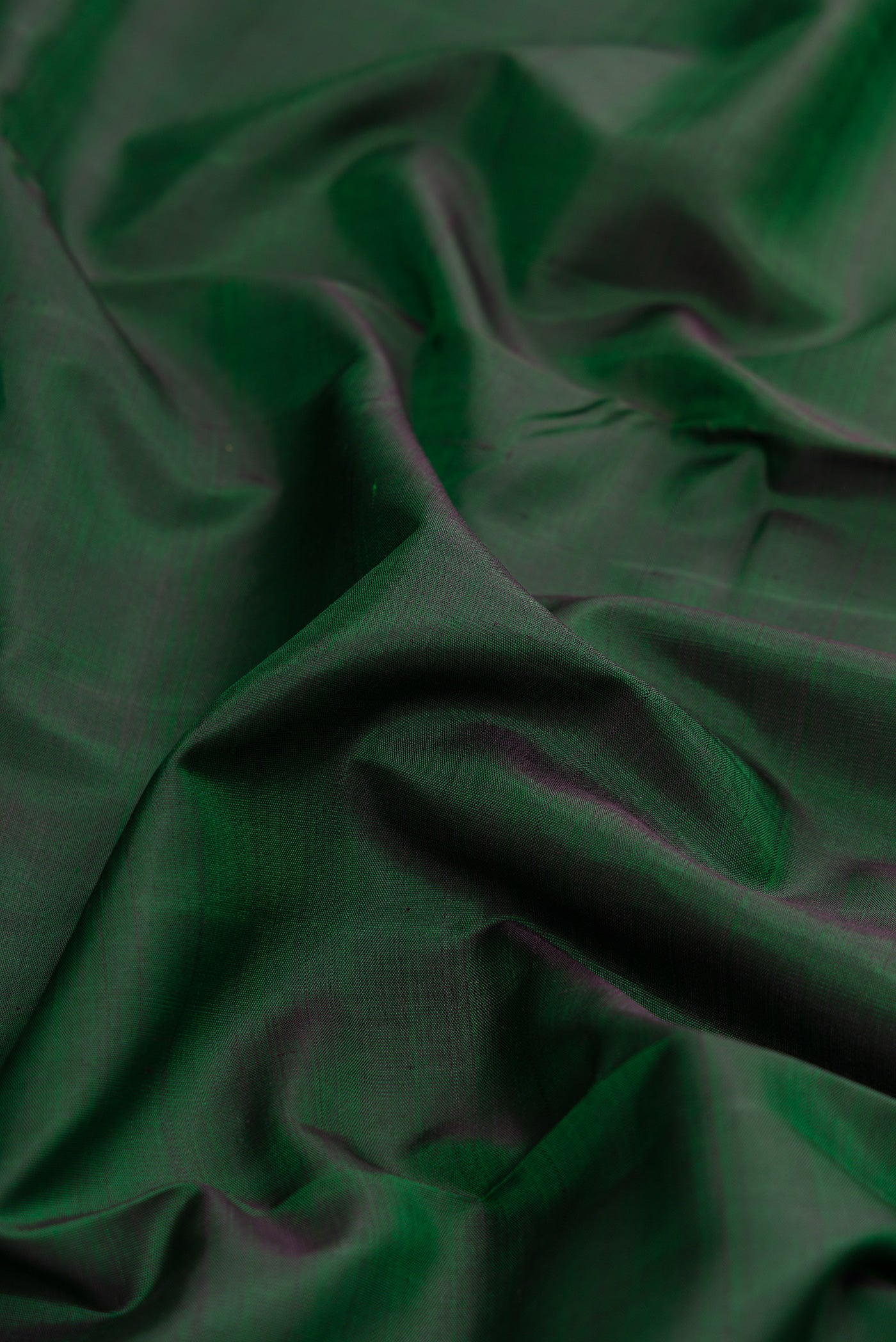 Close up of Pure Silk Pure Zari Bottle Green Dual Tone Kanjivaram Nine Yards Saree with Plain Body and Zari Border.  displaying folds
