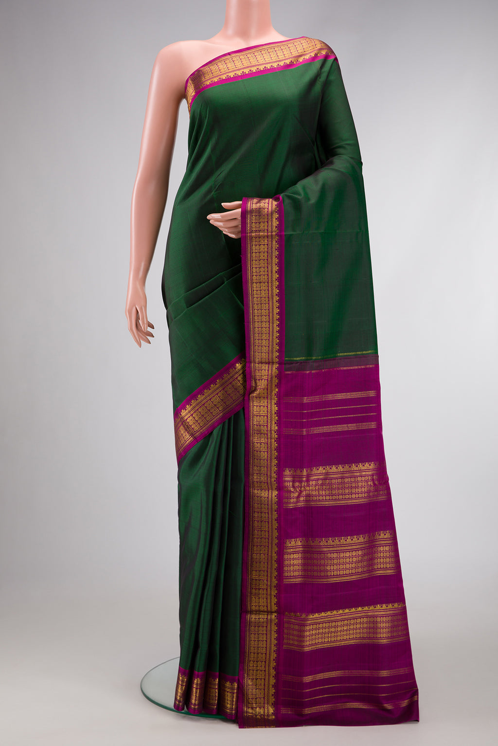 Pure Silk Pure Zari Bottle Green Dual Tone Kanjivaram Nine Yards Saree with Plain Body and Zari Border.  displayed on a mannequin