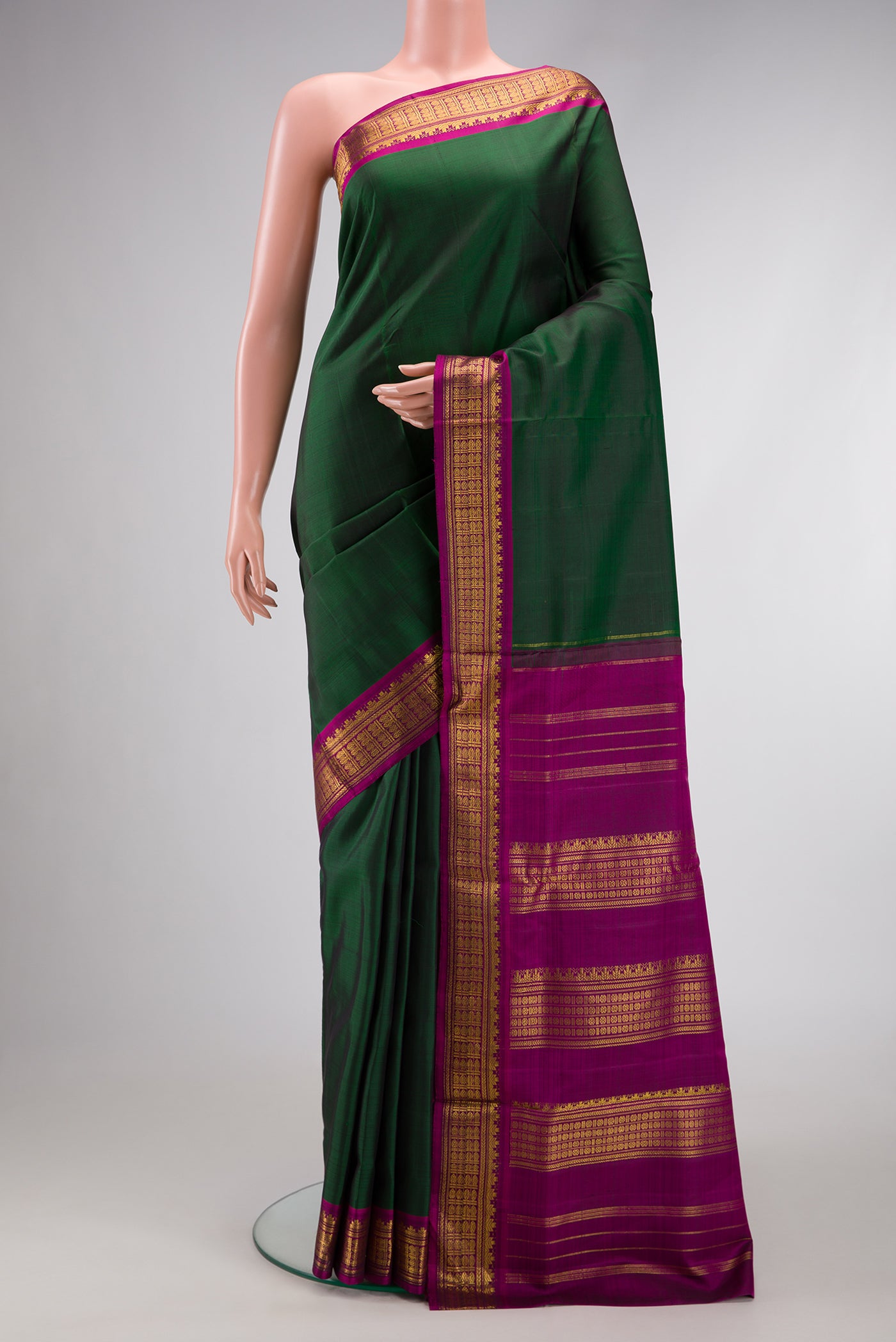 Pure Silk Pure Zari Bottle Green Dual Tone Kanjivaram Nine Yards Saree with Plain Body and Zari Border.  displayed on a mannequin