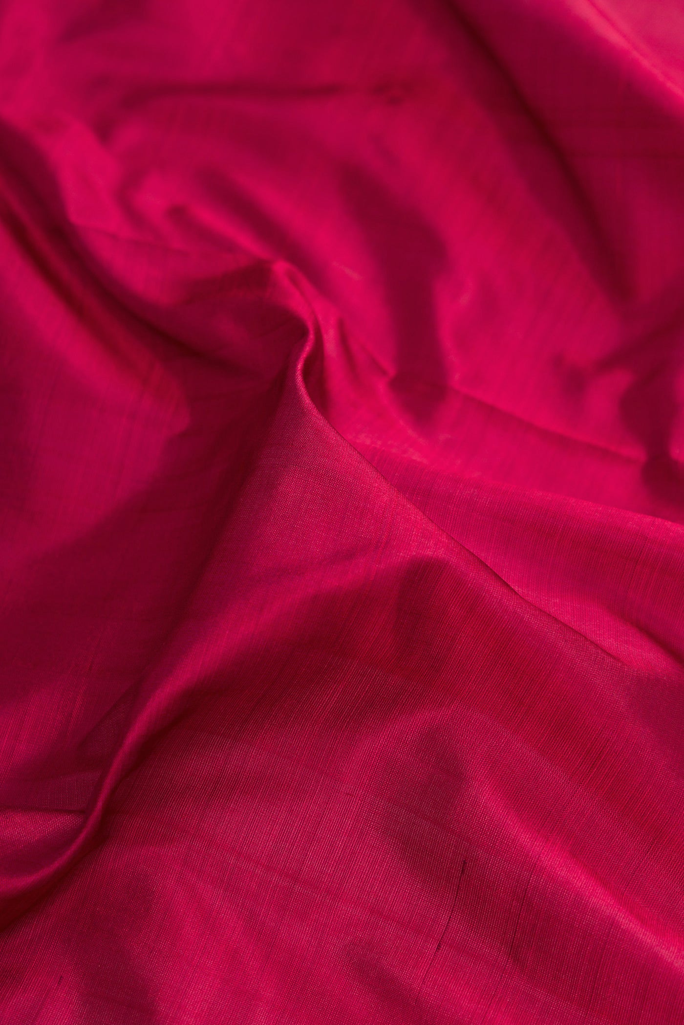 Close up of Maroon Kanchipuram Silk Nine Yards Saree with Plain Body and Zari Border.  displaying folds