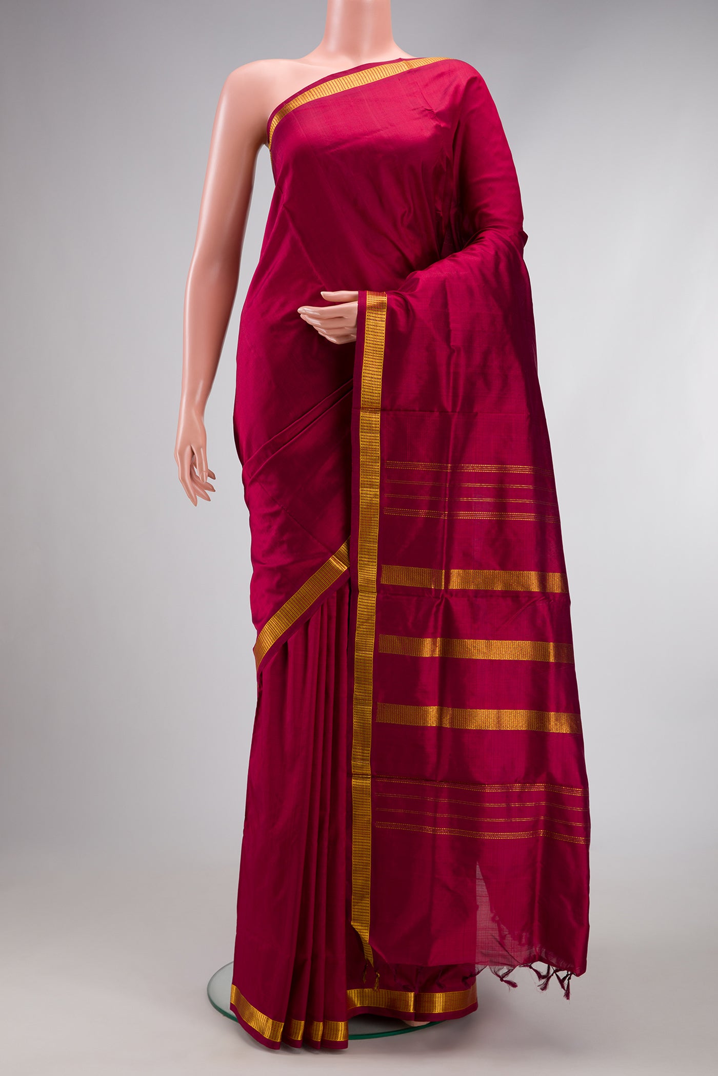 Maroon Kanchipuram Silk Nine Yards Saree with Plain Body and Zari Border.  displayed on a mannequin