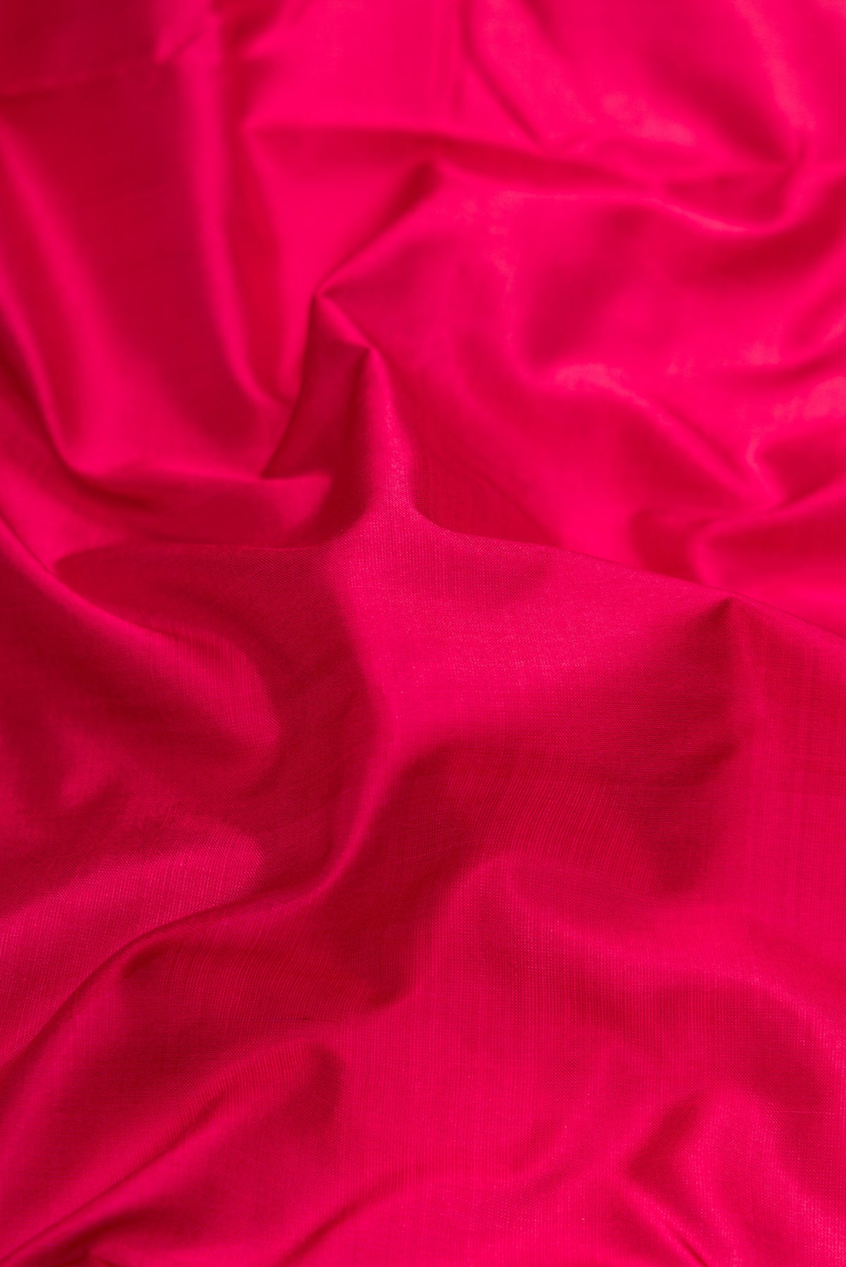 Close up of Maroon Dual Tone Kanchipuram Silk Nine Yards Saree with Plain Body and Zari Border.  displaying folds