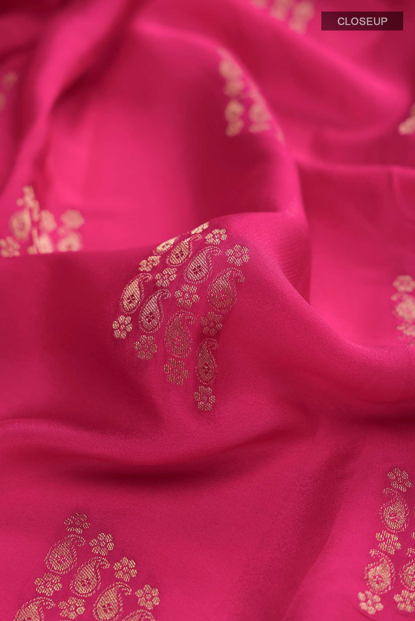 Close up of Pink Mysore Crepe Saree with Zari Butta on the body and Zari Border displaying folds