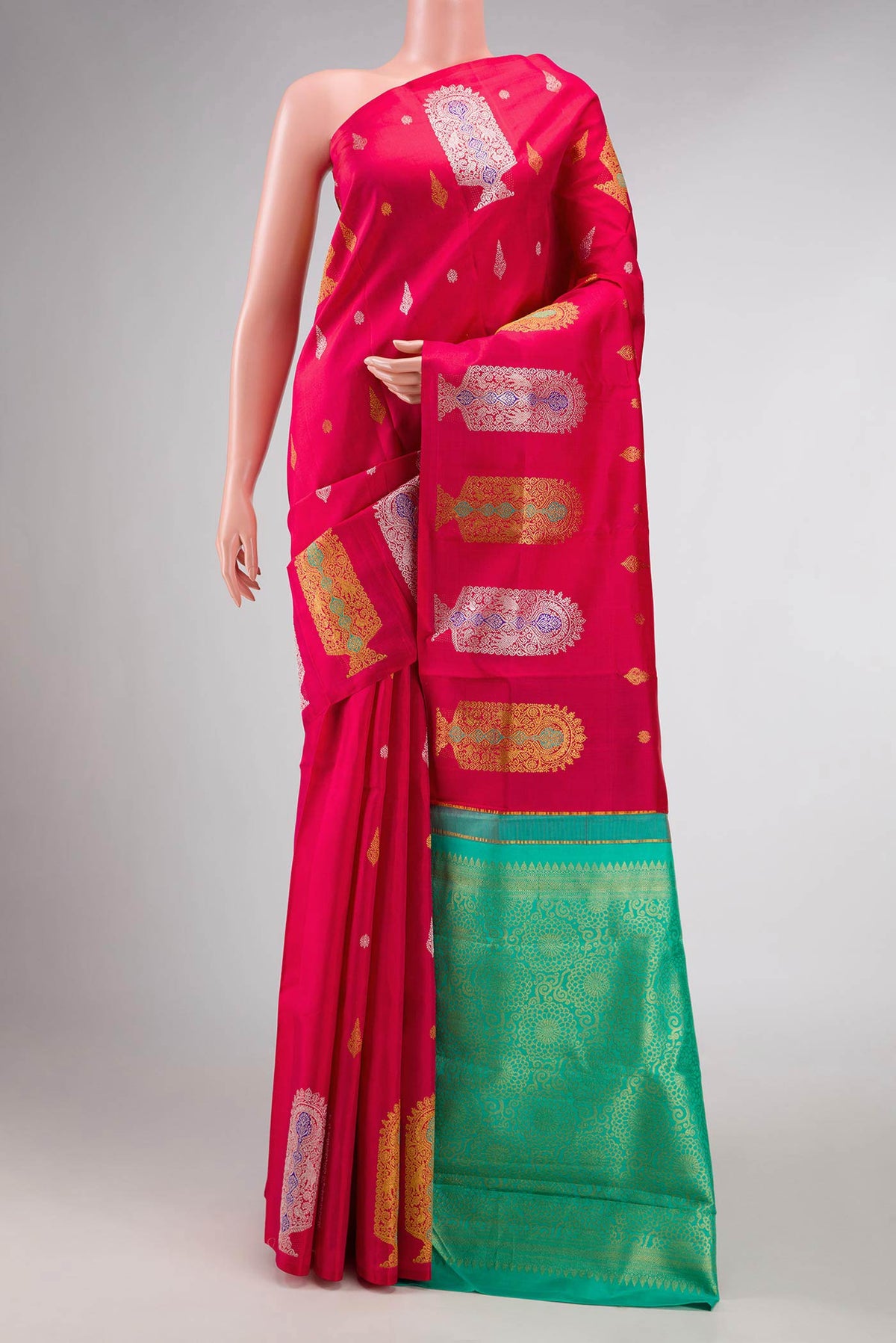 Dark Pink Dual Tone Kanchipuram Silk Saree with Zari Butta on the body and Fancy Border displayed on a mannequin