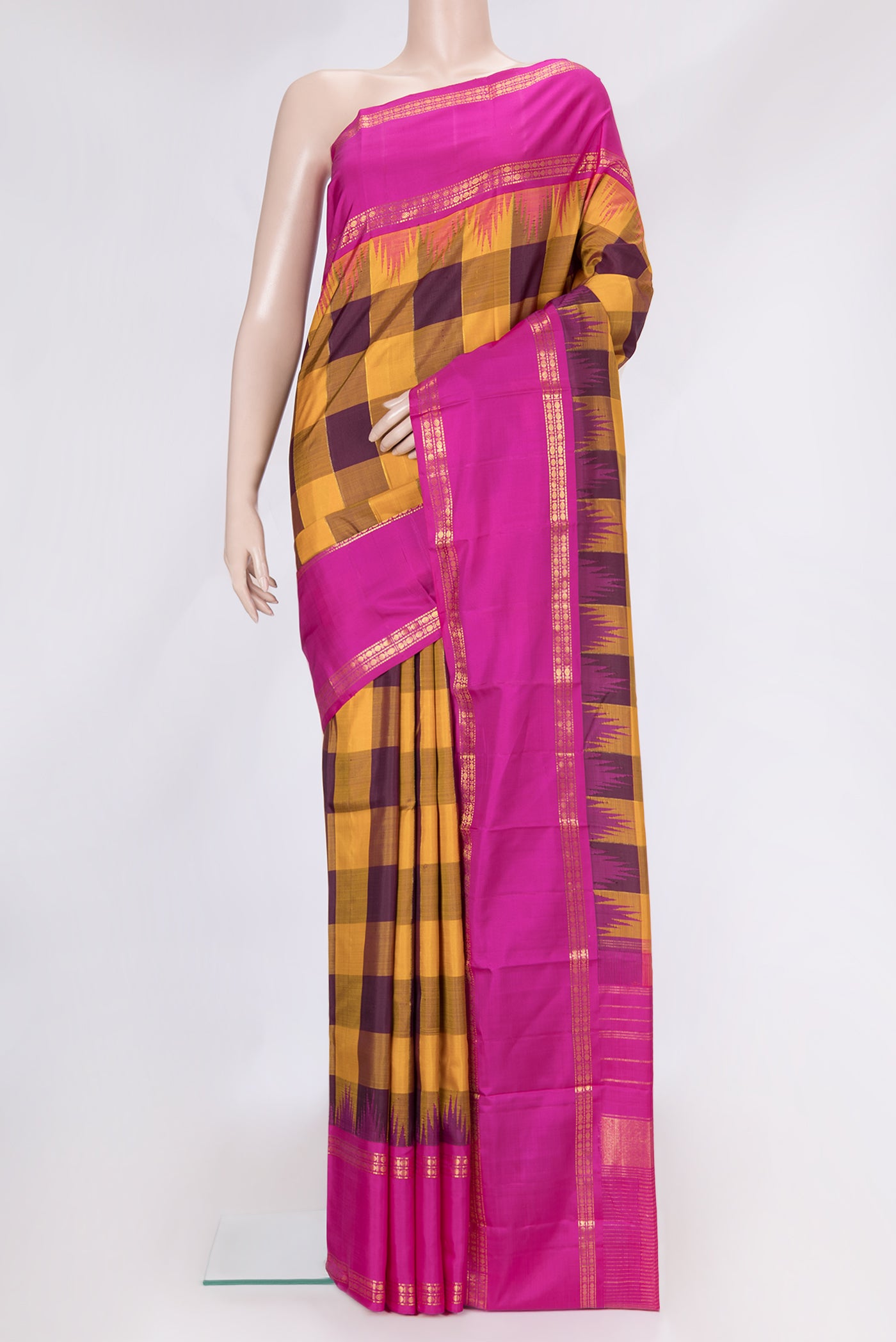 Mustard and Burgundy Color Kanjivaram Silk Saree with Checked design on the body and Zari Border.  displayed on a mannequin