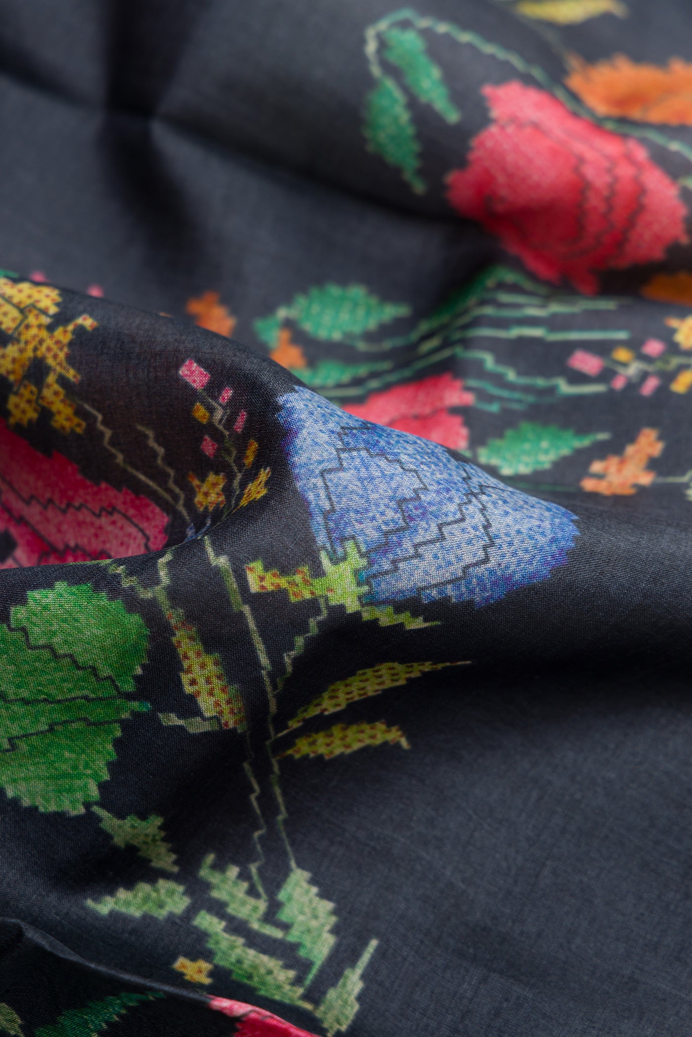 Close up of Navy Blue Dual Tone Tussar Silk Saree with Printed design on the body and Zari Border.  displaying folds
