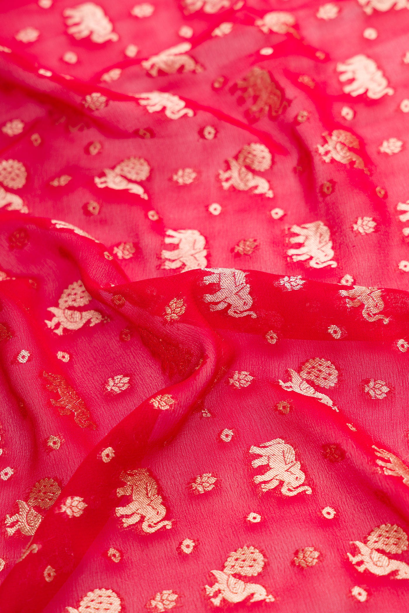 Close up of Maroon Dual Tone Banarasi Georgette Saree with Zari Butta on the body and Zari Border.  displaying folds