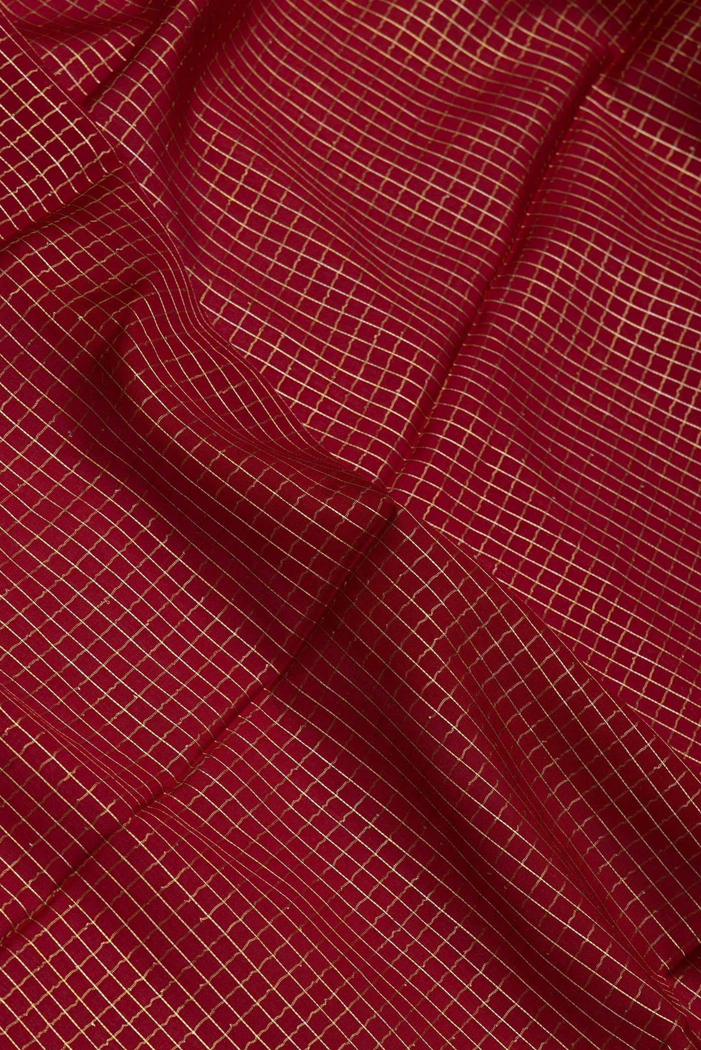Close up of Maroon Mysore Silk Saree with Checked design on the body and Zari Border.  displaying folds