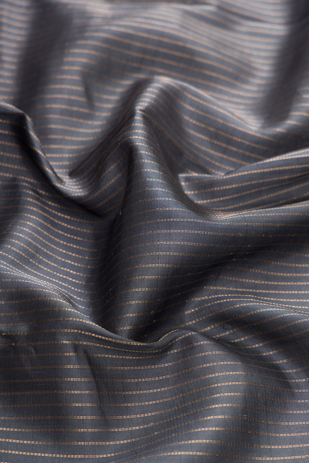 Close up of Grey Dual Tone Kanchipuram Silk Saree with Stripes on the body and Zari Border.  displaying folds