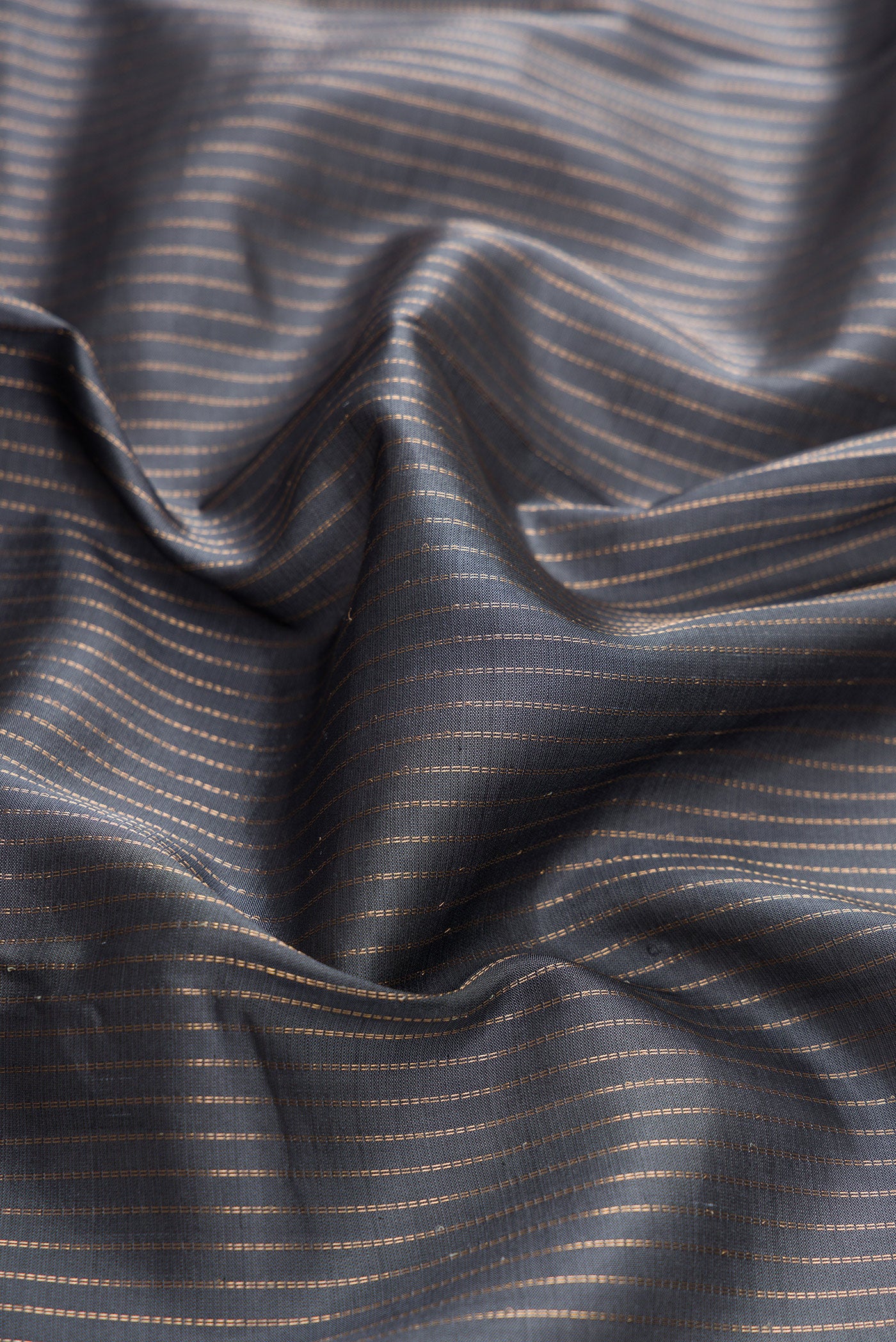 Close up of Grey Dual Tone Kanchipuram Silk Saree with Stripes on the body and Zari Border.  displaying folds