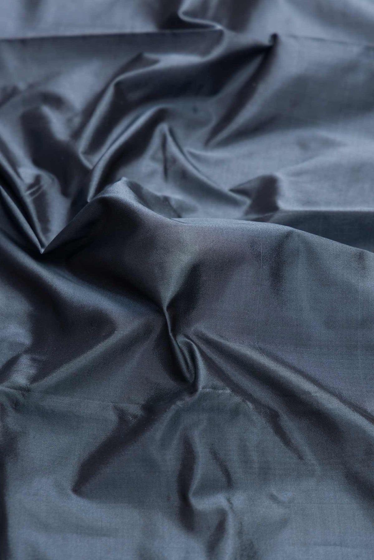 Close up of Blue Grey Bangalore Silk Saree with Plain Body and Temple Border displaying folds