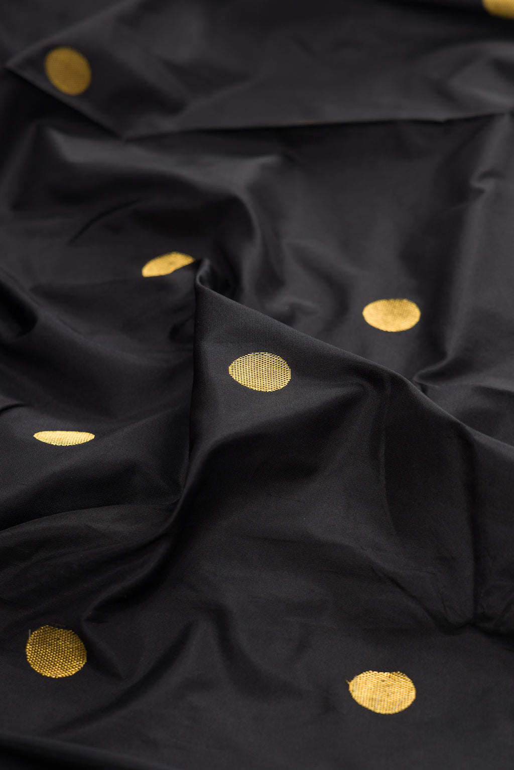 Close up of Pure Silk Black Bangalore Saree with Zari Butta on the body and Temple Border.  displaying folds