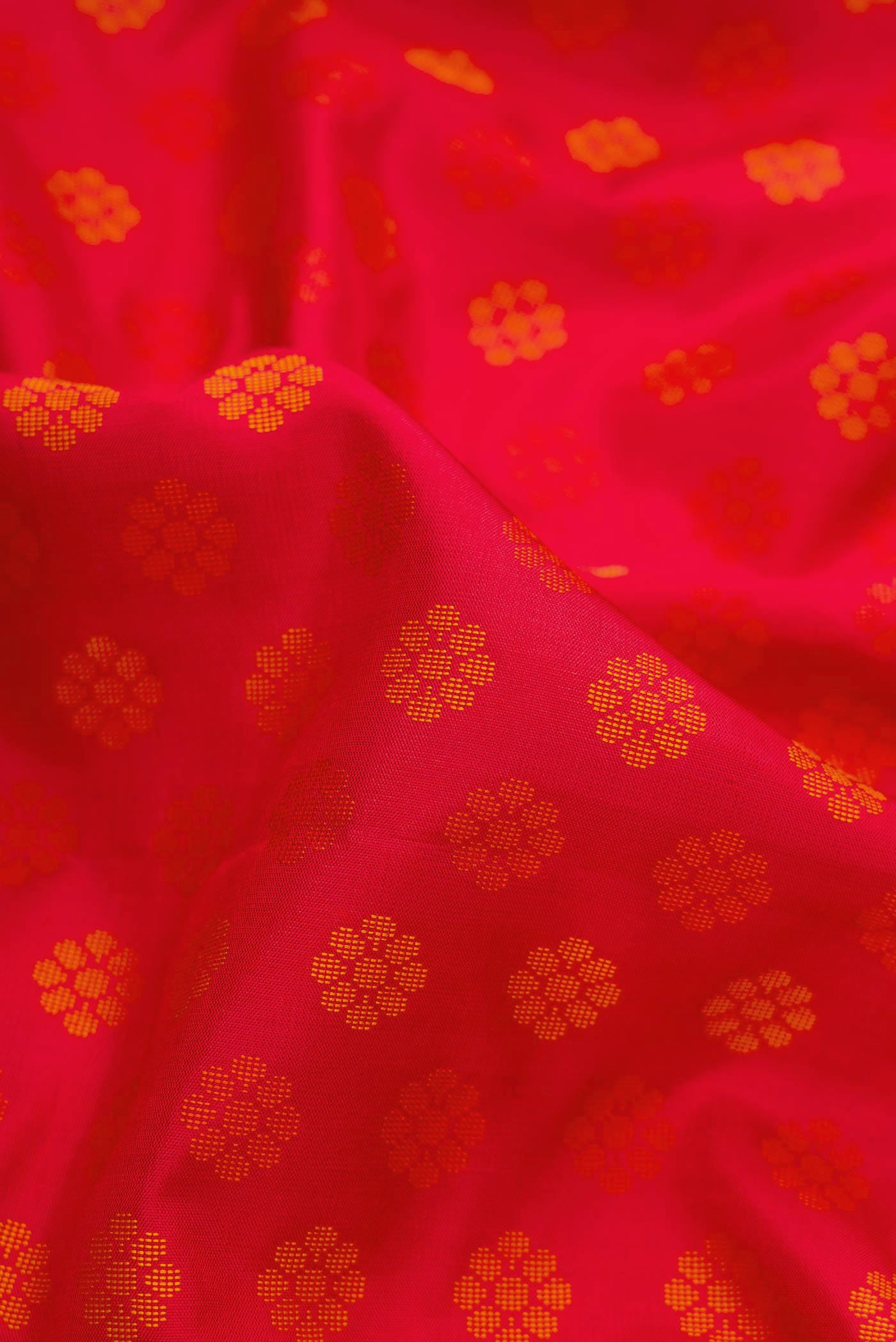 Close up of Red Dual Tone Soft Silk Saree with Thread Butta on the body and Plain Border.  displaying folds