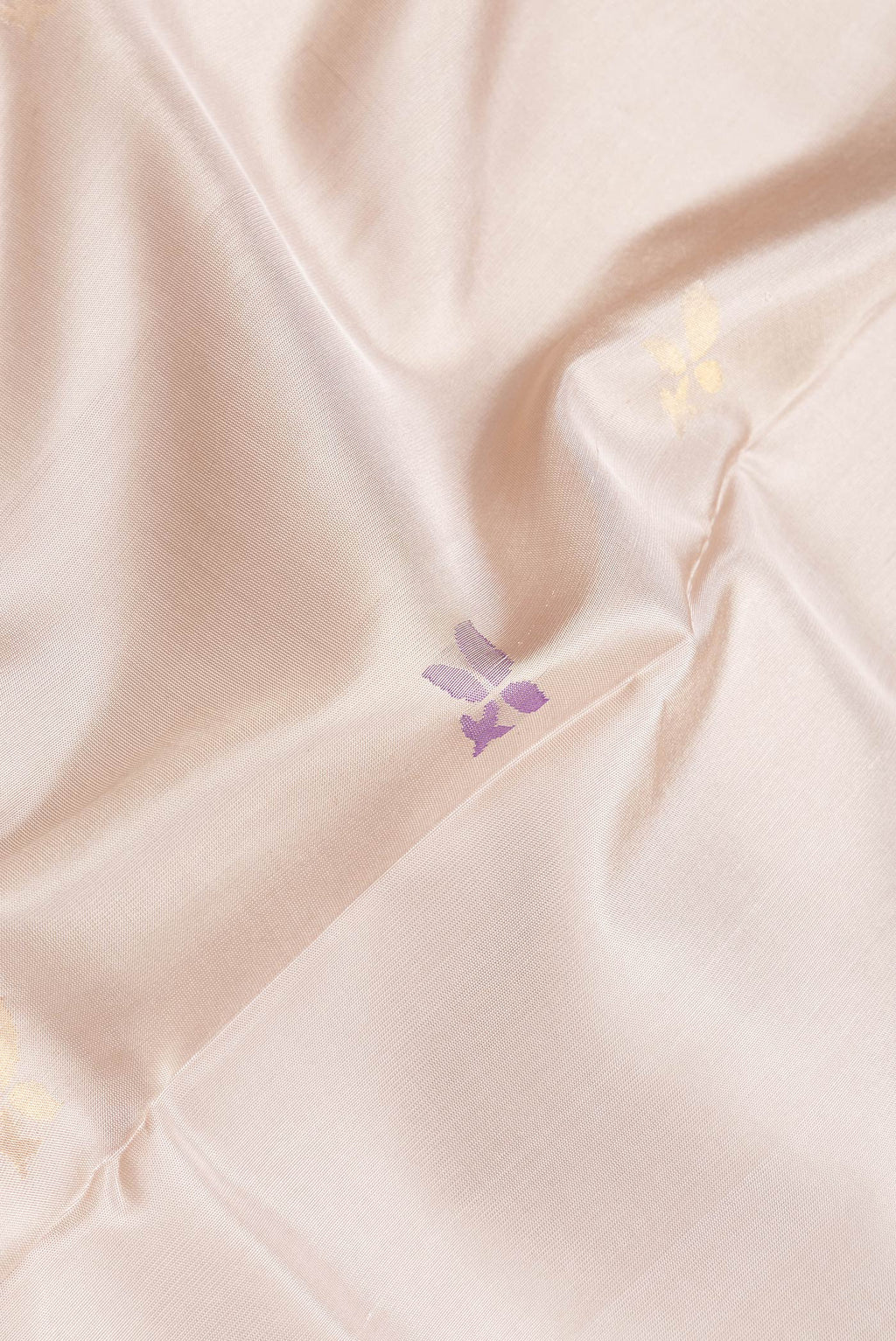 Close up of Beige Dual Tone Uppada Silk Saree with Zari And Thread Butta on the body and Zari Border.  displaying folds