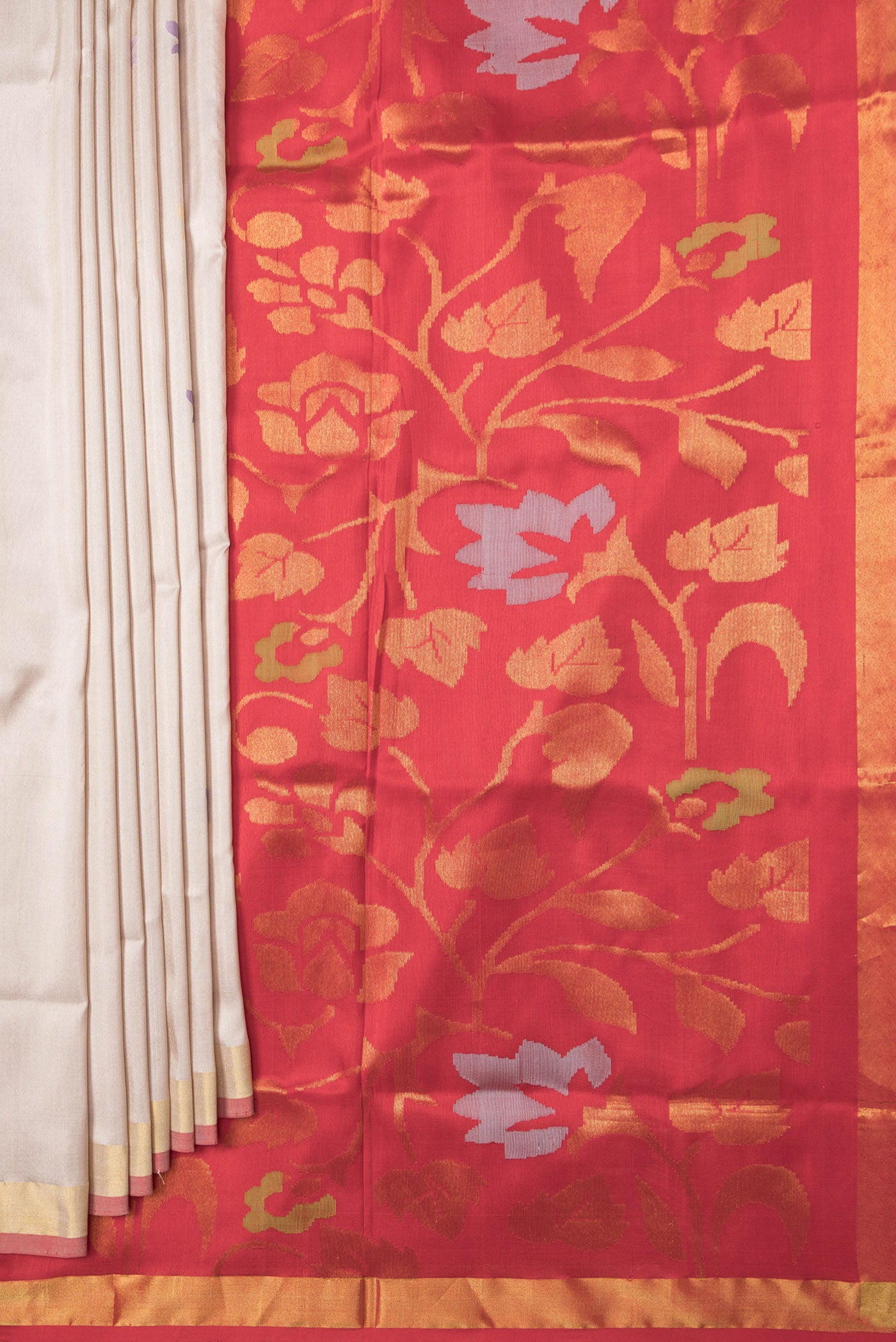 Pleats and pallu of Beige Dual Tone Uppada Silk Saree with Zari And Thread Butta on the body and Zari Border. 