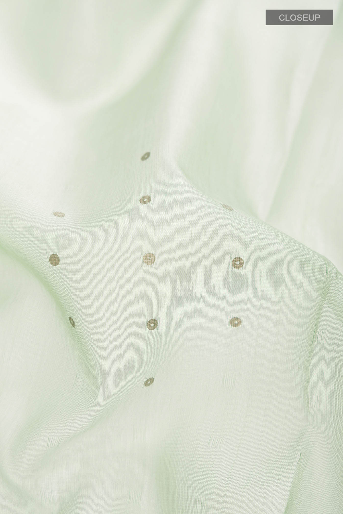Close up of Green Organza Silk Saree with Embroidery on the body and Embroidery Border displaying folds