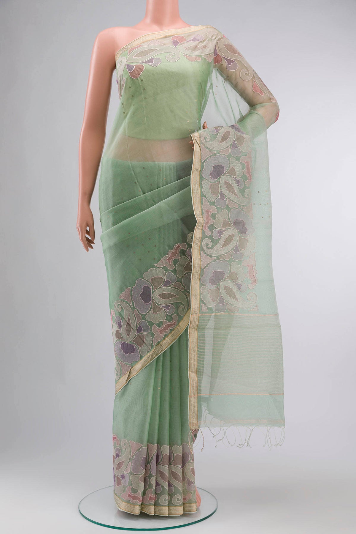 Green Organza Silk Saree with Embroidery on the body and Embroidery Border displayed on a mannequin