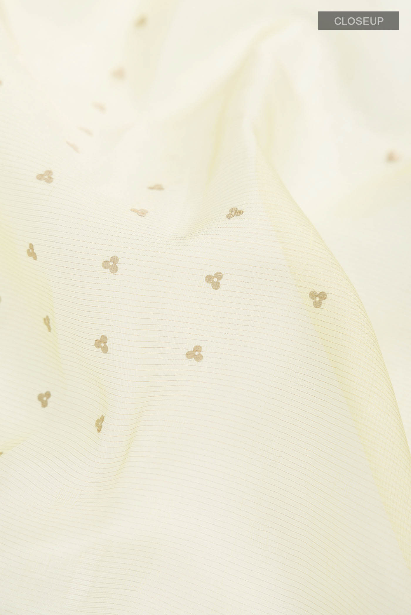 Close up of Yellow Organza Silk Saree with Embroidery on the body and Embroidery Border displaying folds