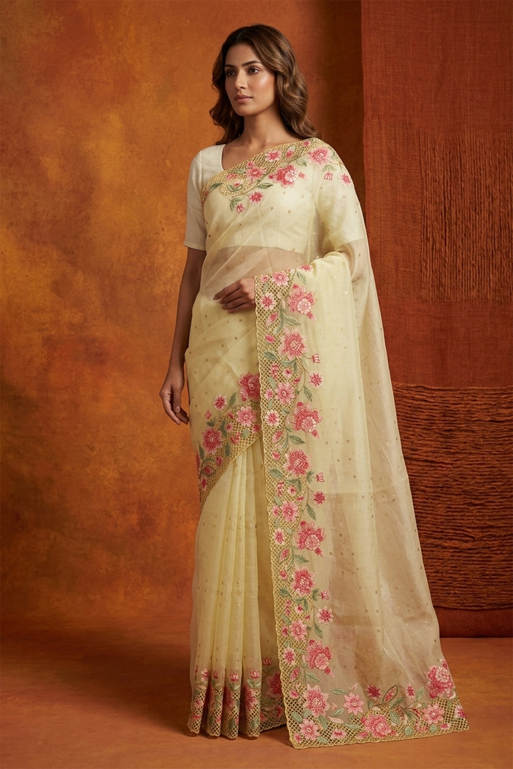Model wearing a Lemon Yellow Organza Silk Saree with Embroidery on the body and Embroidery Border.