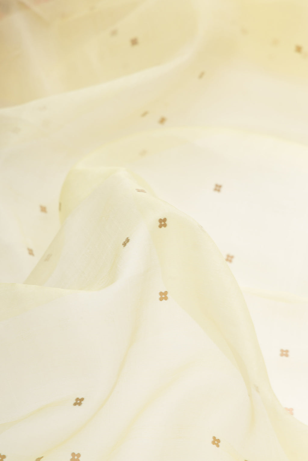 Close up of Lemon Yellow Dual Tone Organza Silk Saree with Embroidery on the body and Embroidery Border.  displaying folds