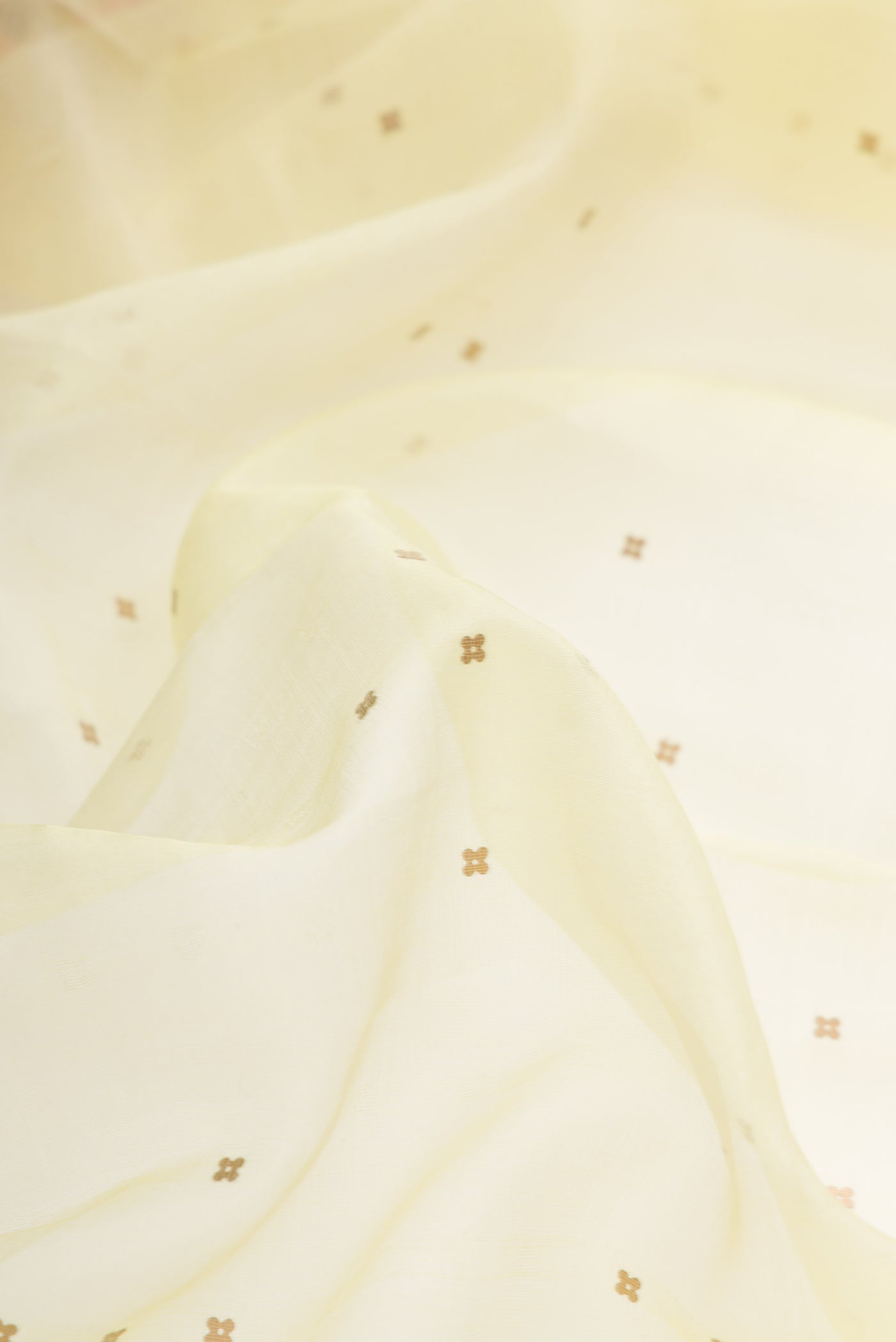 Close up of Lemon Yellow Dual Tone Organza Silk Saree with Embroidery on the body and Embroidery Border.  displaying folds